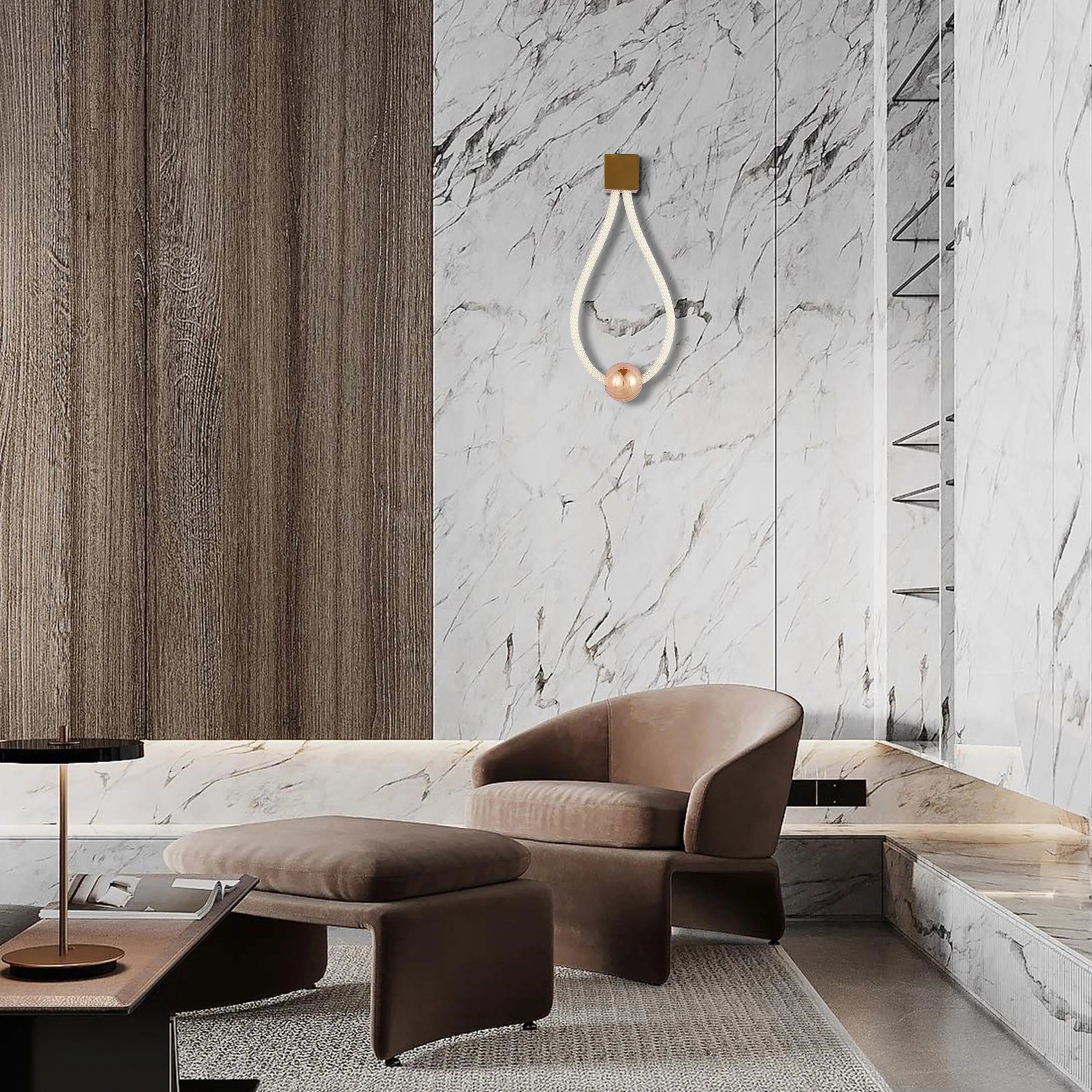 A modern interior showcases a unique wall light with a decorative rope and copper sphere, creating a sophisticated ambience.