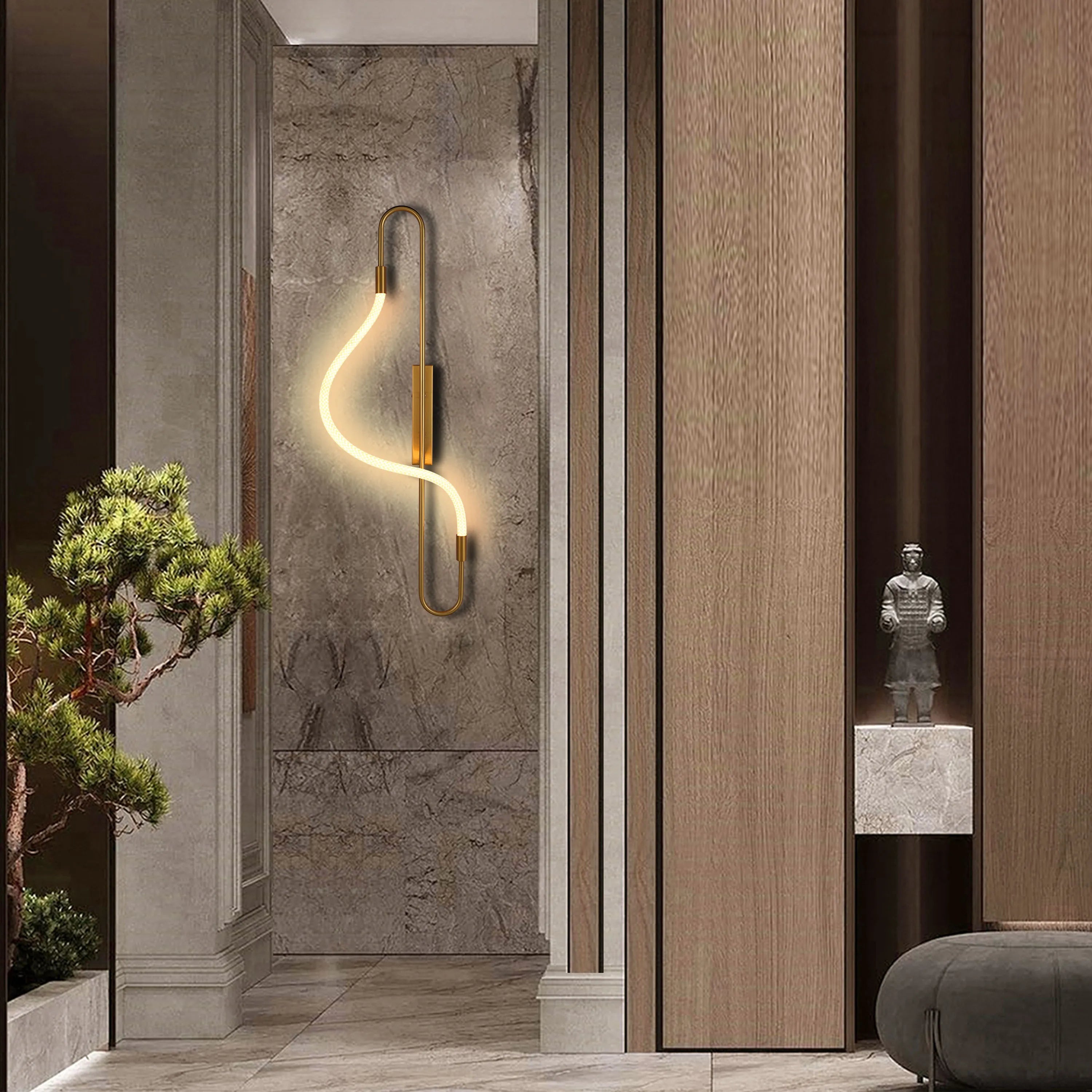 A modern, stylish wall light casts a warm glow, complemented by sleek wood panelling and elegant marble textures.