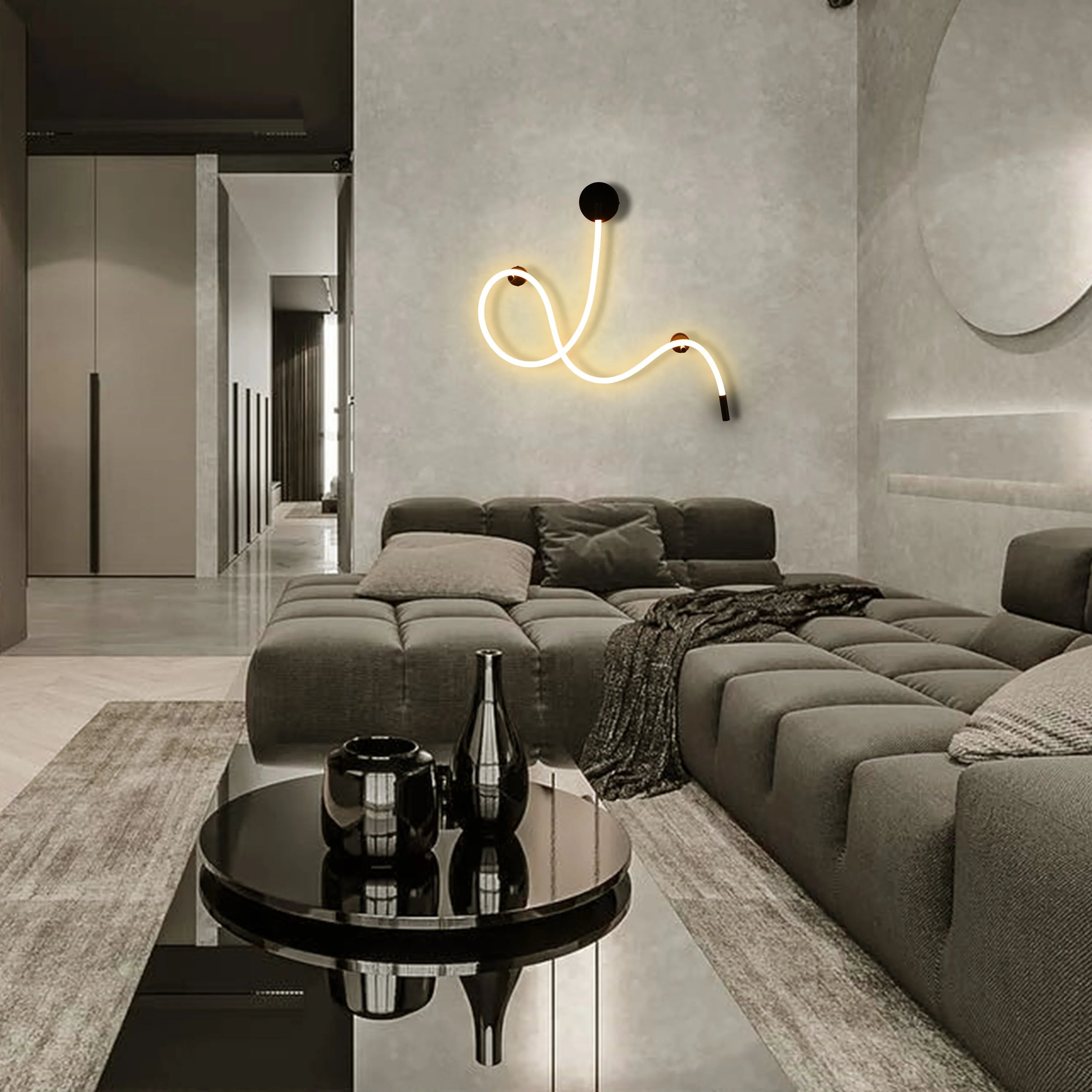 A contemporary neon wall light provides a warm glow, complementing the neutral tones of this modern living room.