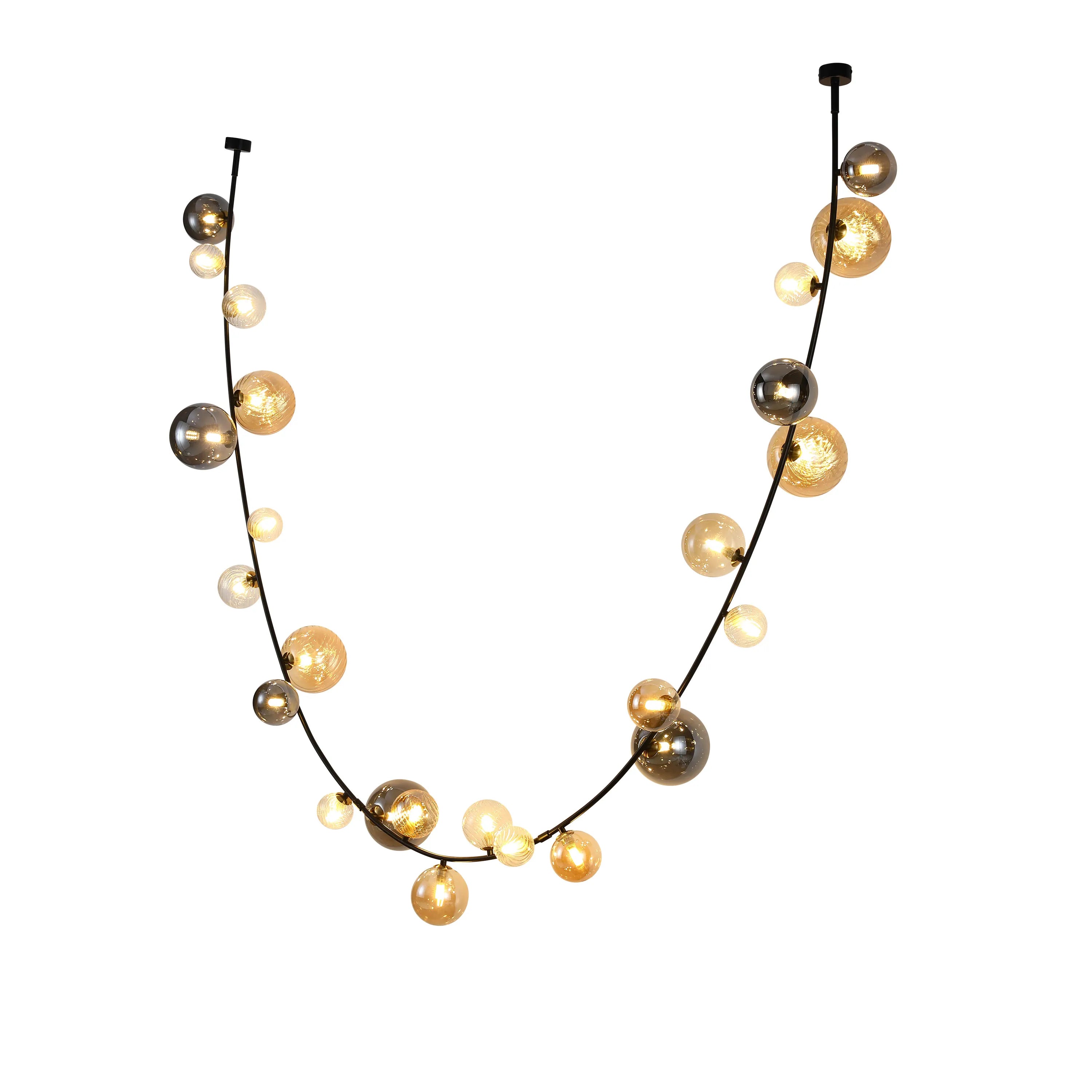 Contemporary cluster pendant light with illuminated glass spheres along a black metal frame. Statement lighting for modern interiors.