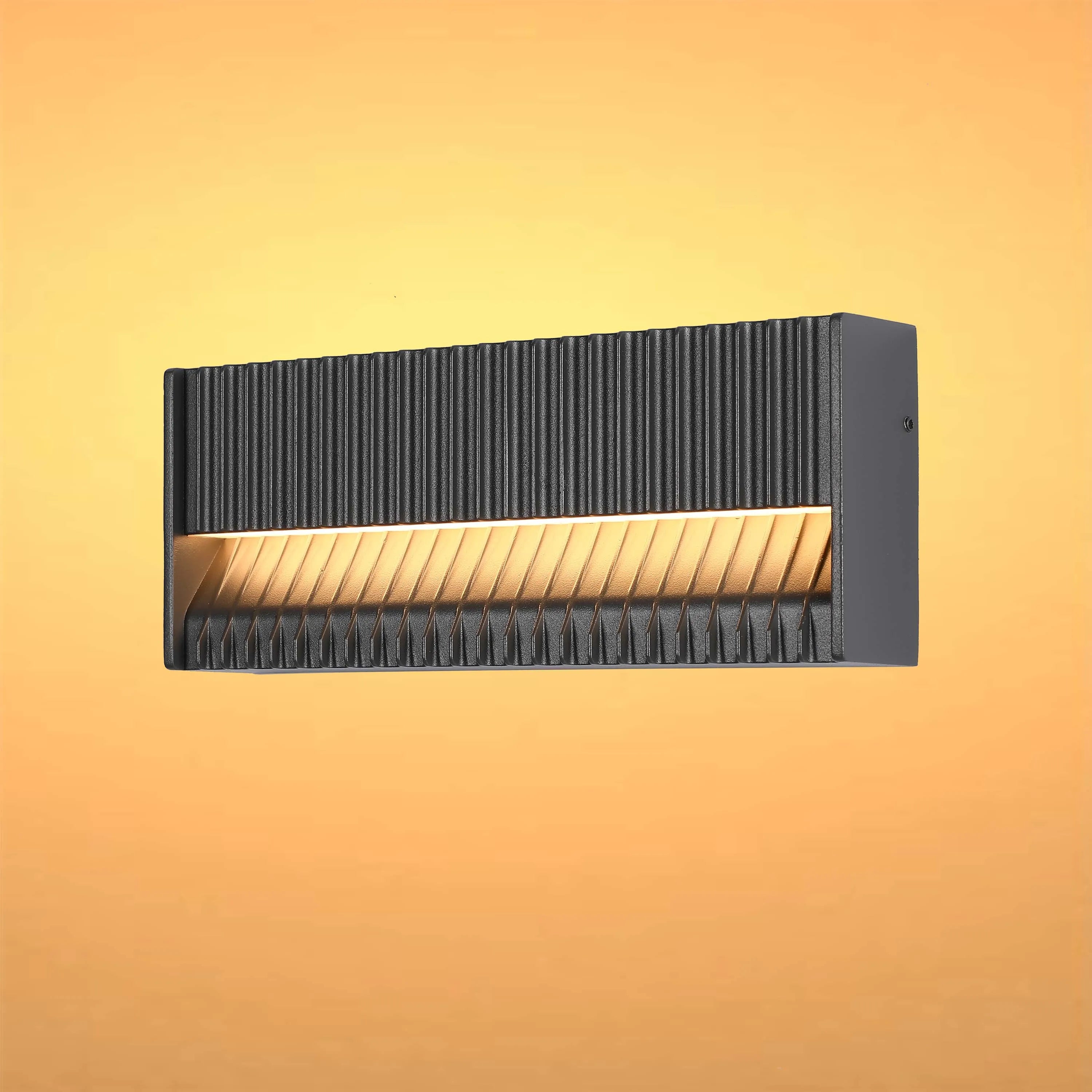 Stylish grey wall light with a ribbed design, emanating a warm, inviting glow. Modern and sleek lighting.