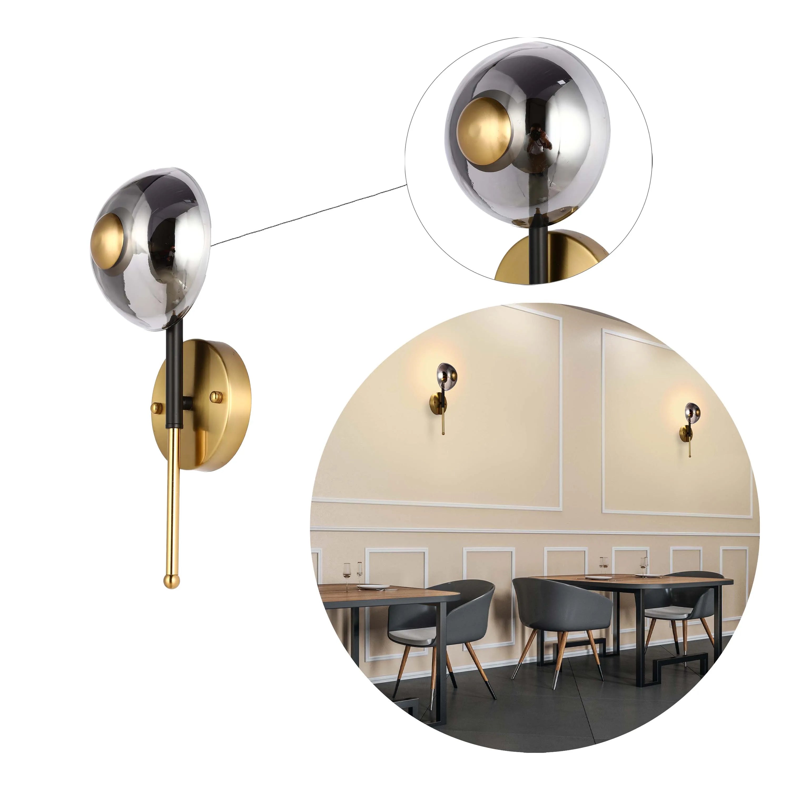 Modern wall sconce with a spherical glass shade and gold accents, displayed in a dining setting with similar lighting.