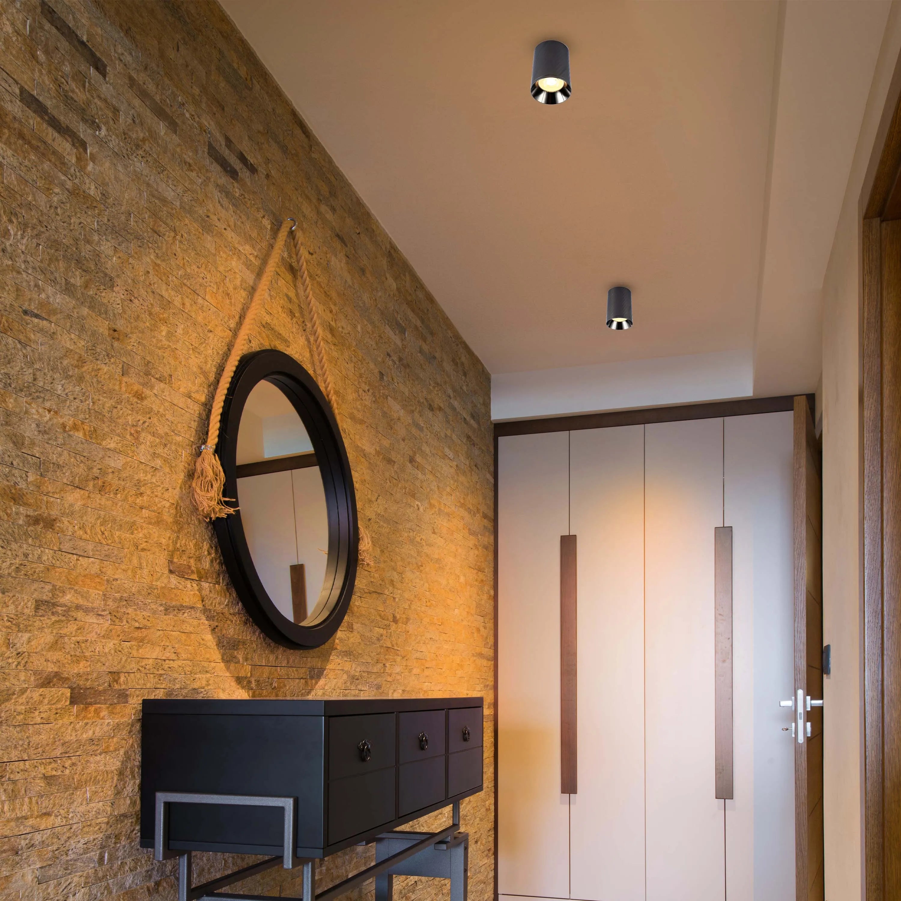 Modern ceiling lights illuminate the hallway, creating a bright and inviting space with focused pools of light.