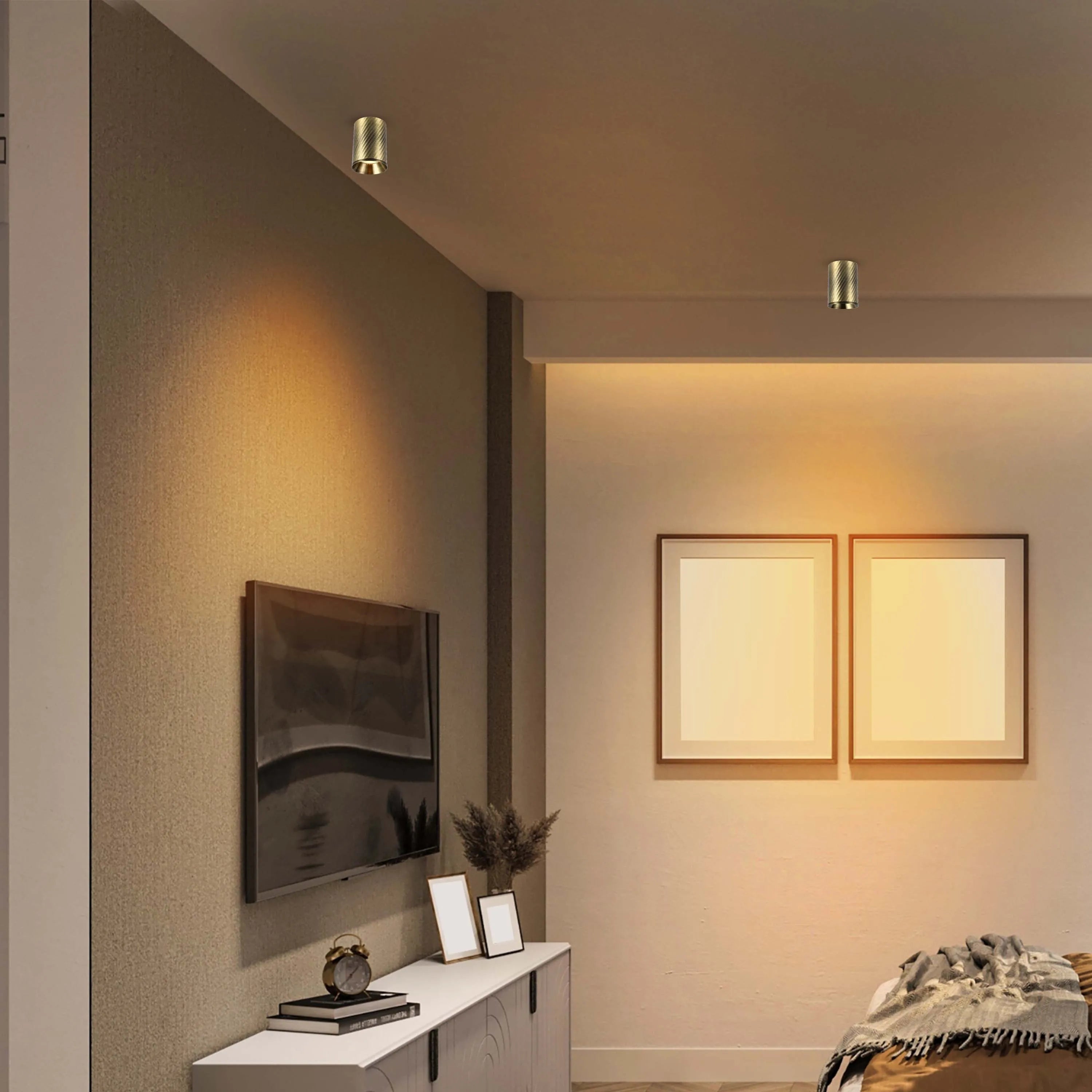 Warm, ambient lighting from ceiling-mounted spotlights creates a cosy atmosphere in this living space.