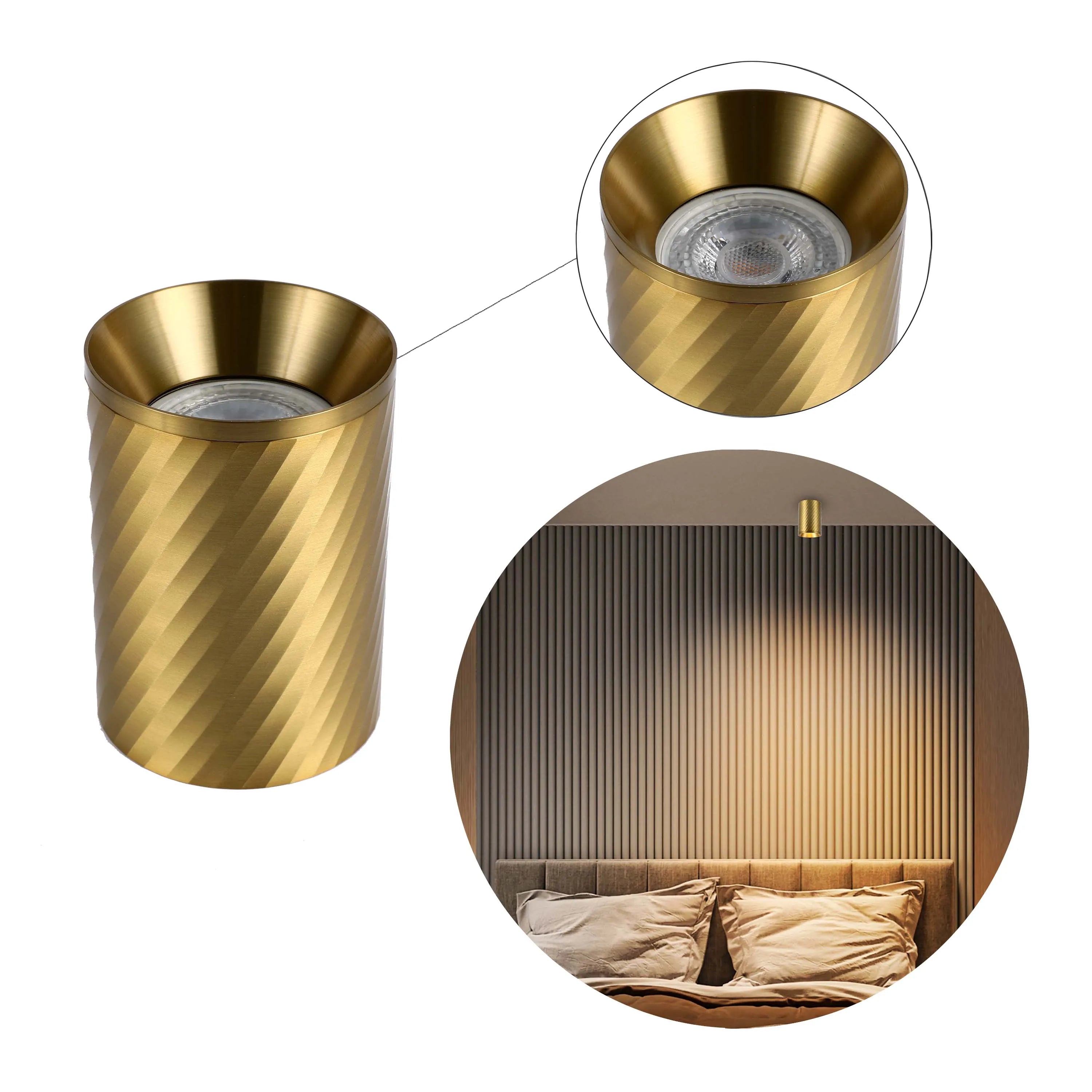 A stylish gold wall light provides warm ambient lighting, perfect for bedside reading or adding a touch of elegance to any room.