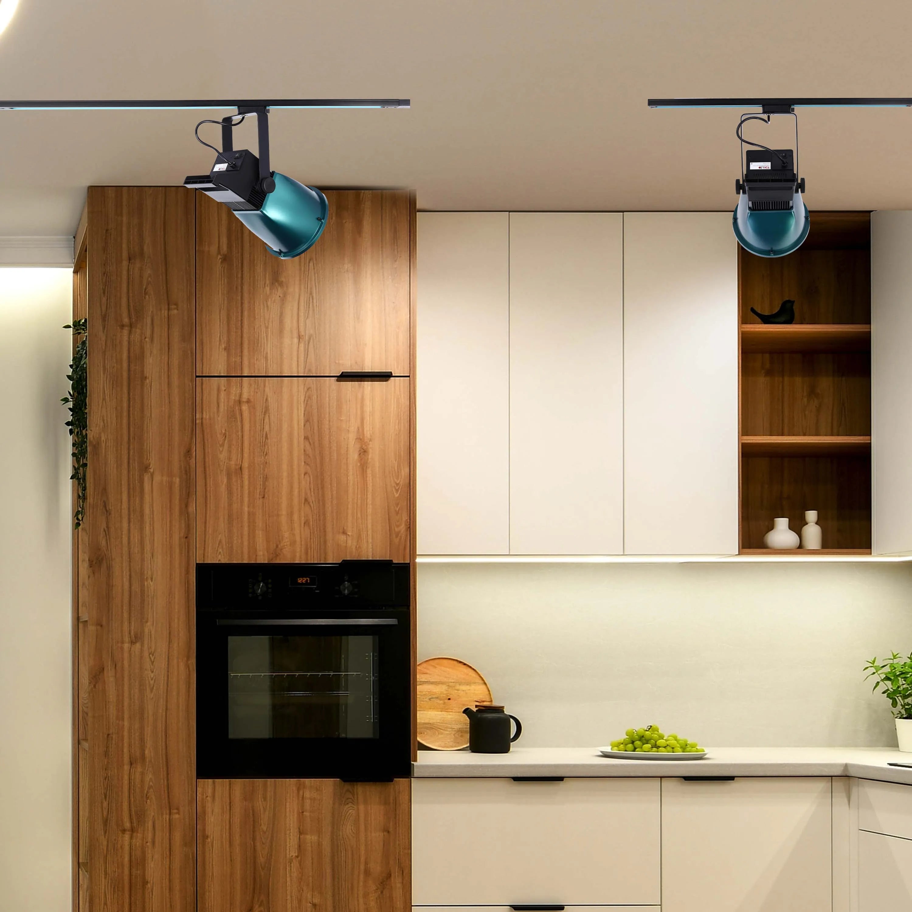 Track lighting with adjustable spotlights illuminate this modern kitchen. The sleek design complements the contemporary cabinetry.
