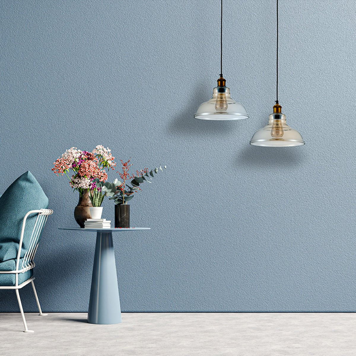 Contemporary living room featuring a stylish chair, a pedestal table with flower arrangements, and two hanging pendant lights.