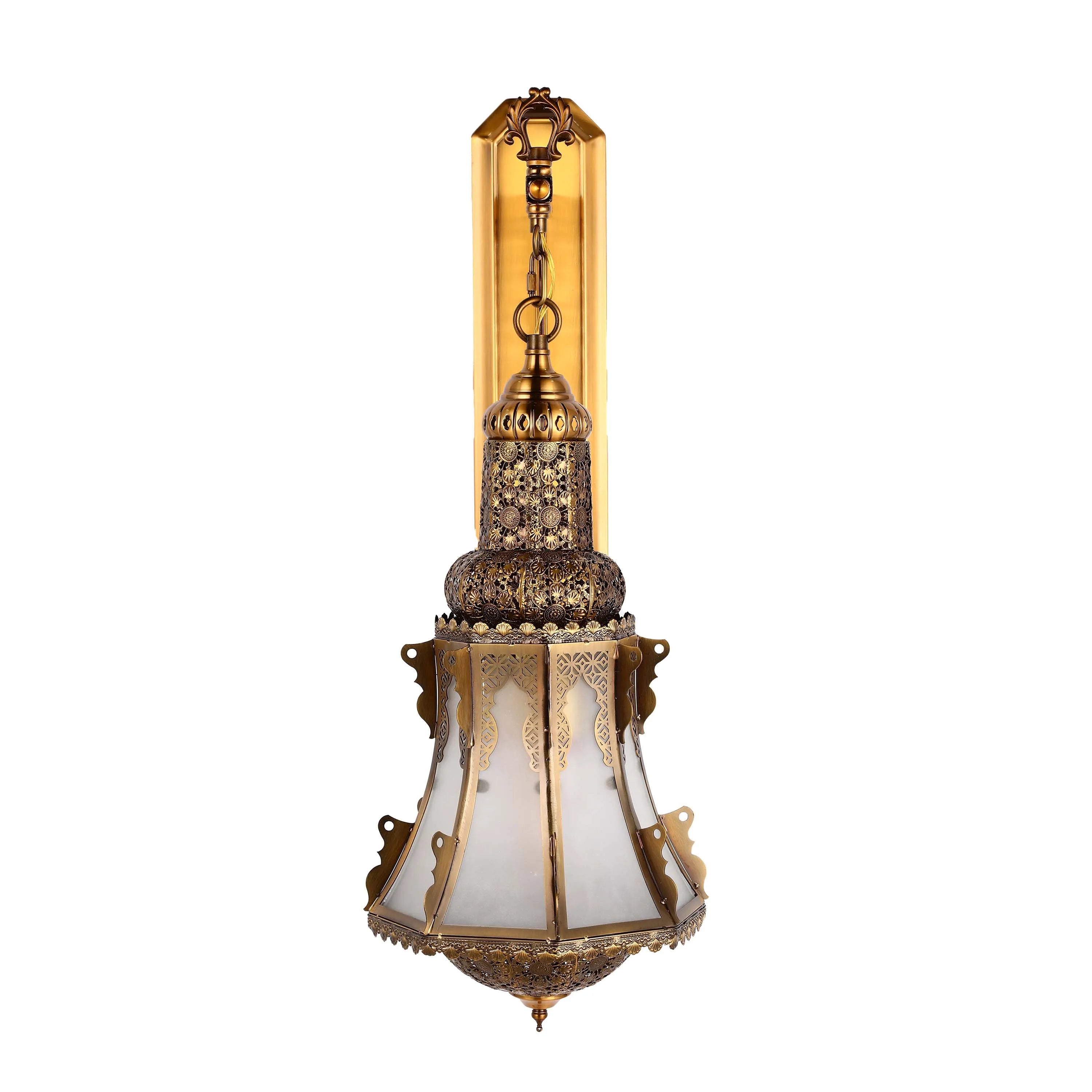 Ornate gold wall light with patterned shade. Decorative and adds a touch of class to any room.