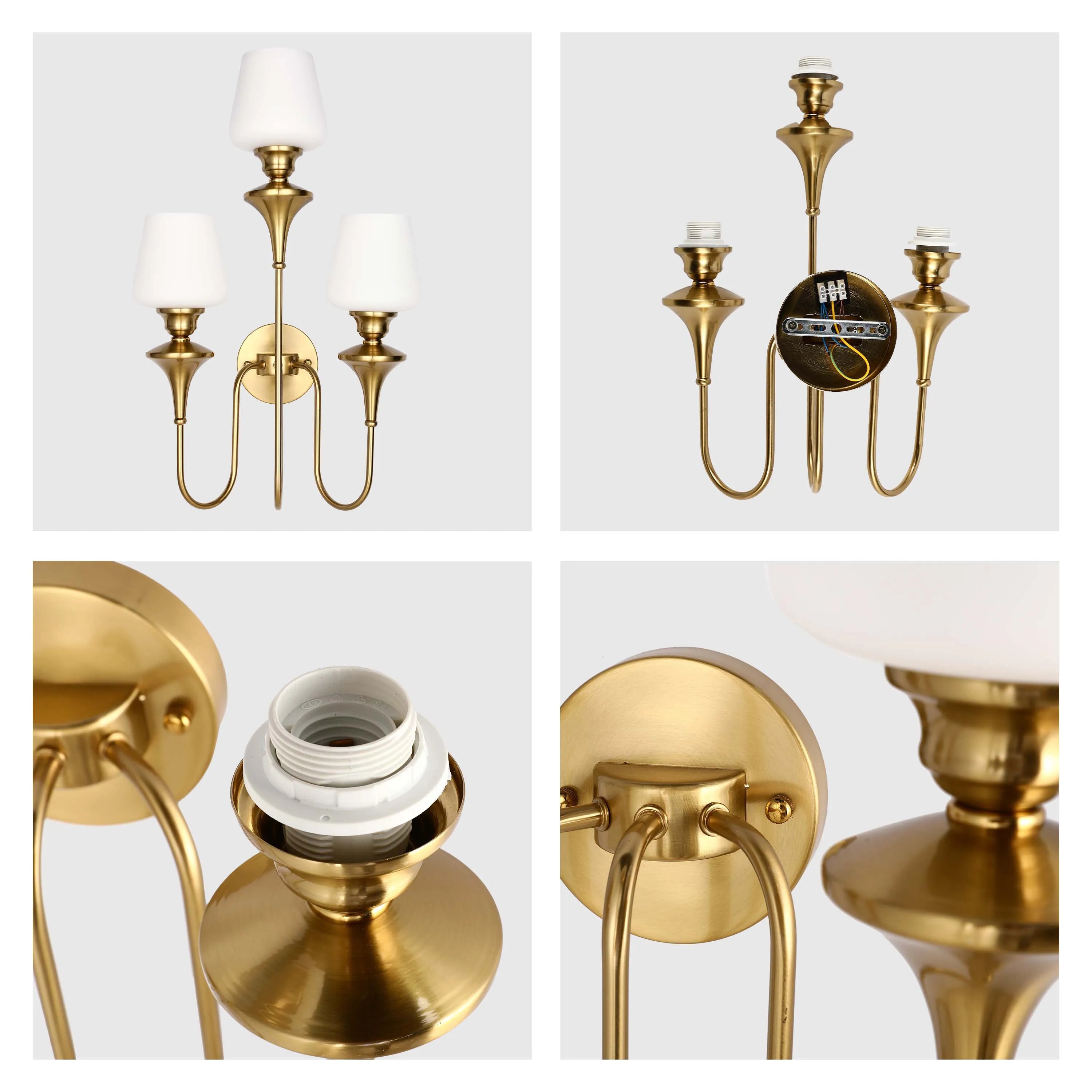 A three-light wall sconce with a gold finish and white shades, showcasing a traditional and elegant design.