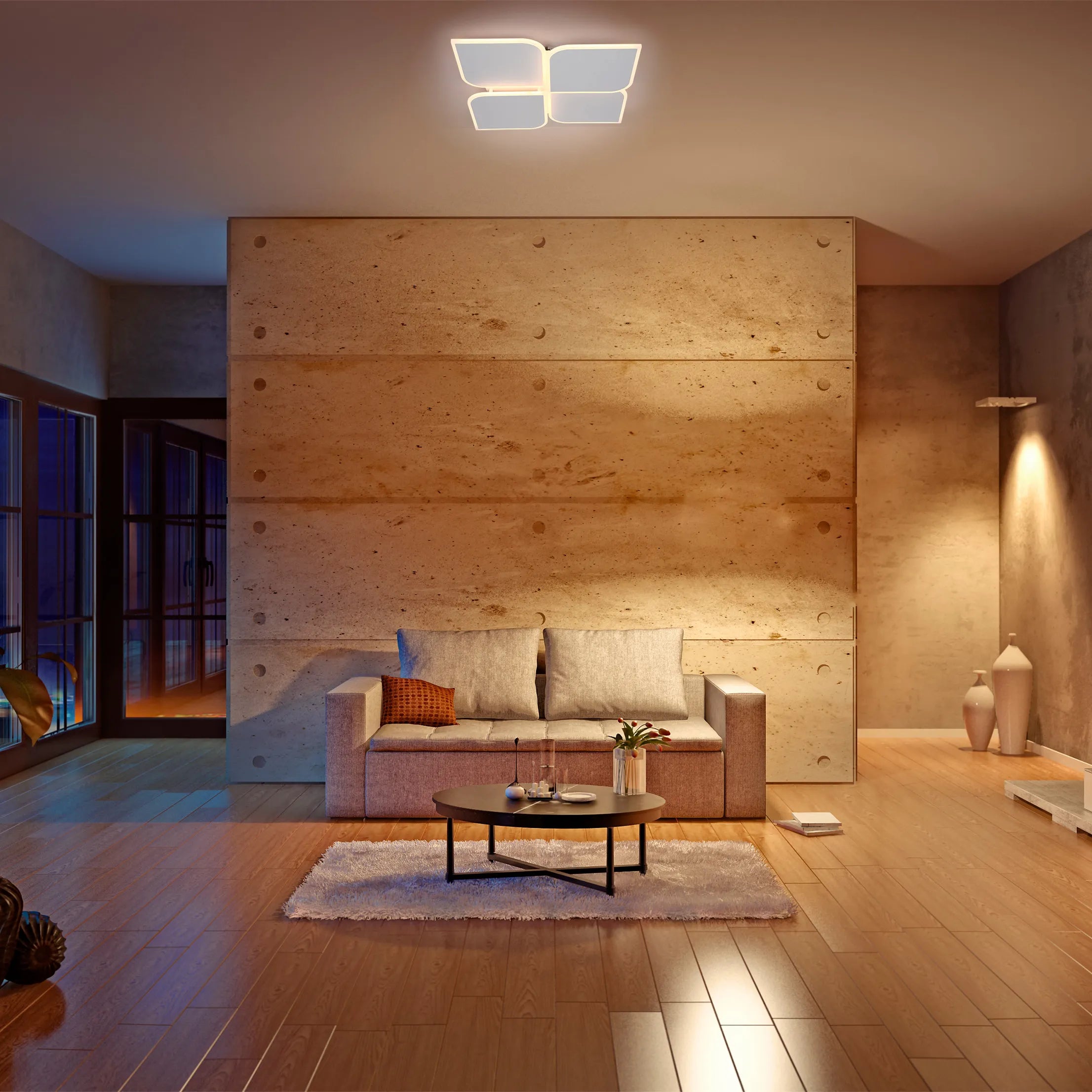 The room features overhead feature lighting alongside warm spotlights which highlight vases and textured walls.