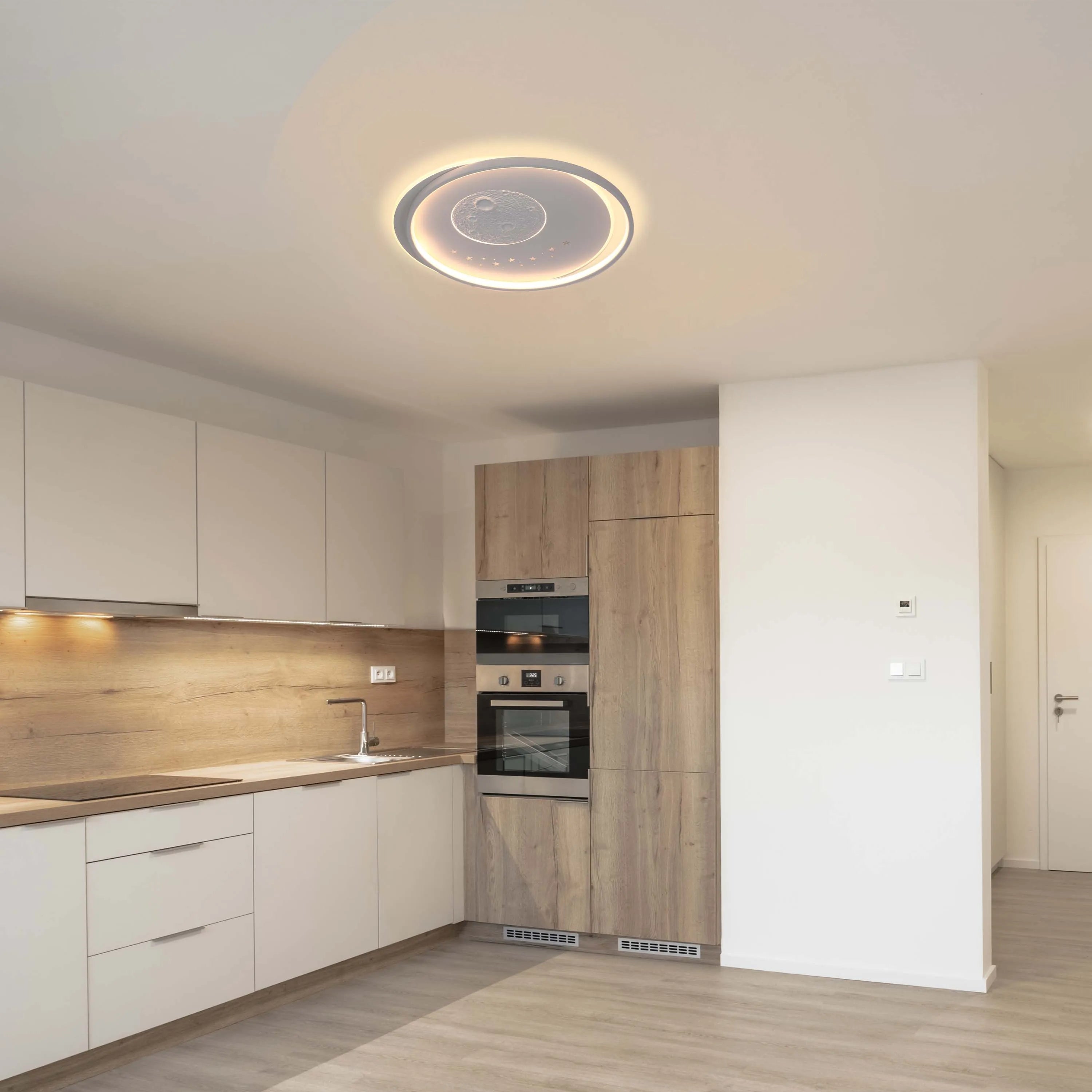 Modern kitchen lighting featuring a unique circular LED ceiling light with a moon design, creating a warm and inviting ambience.