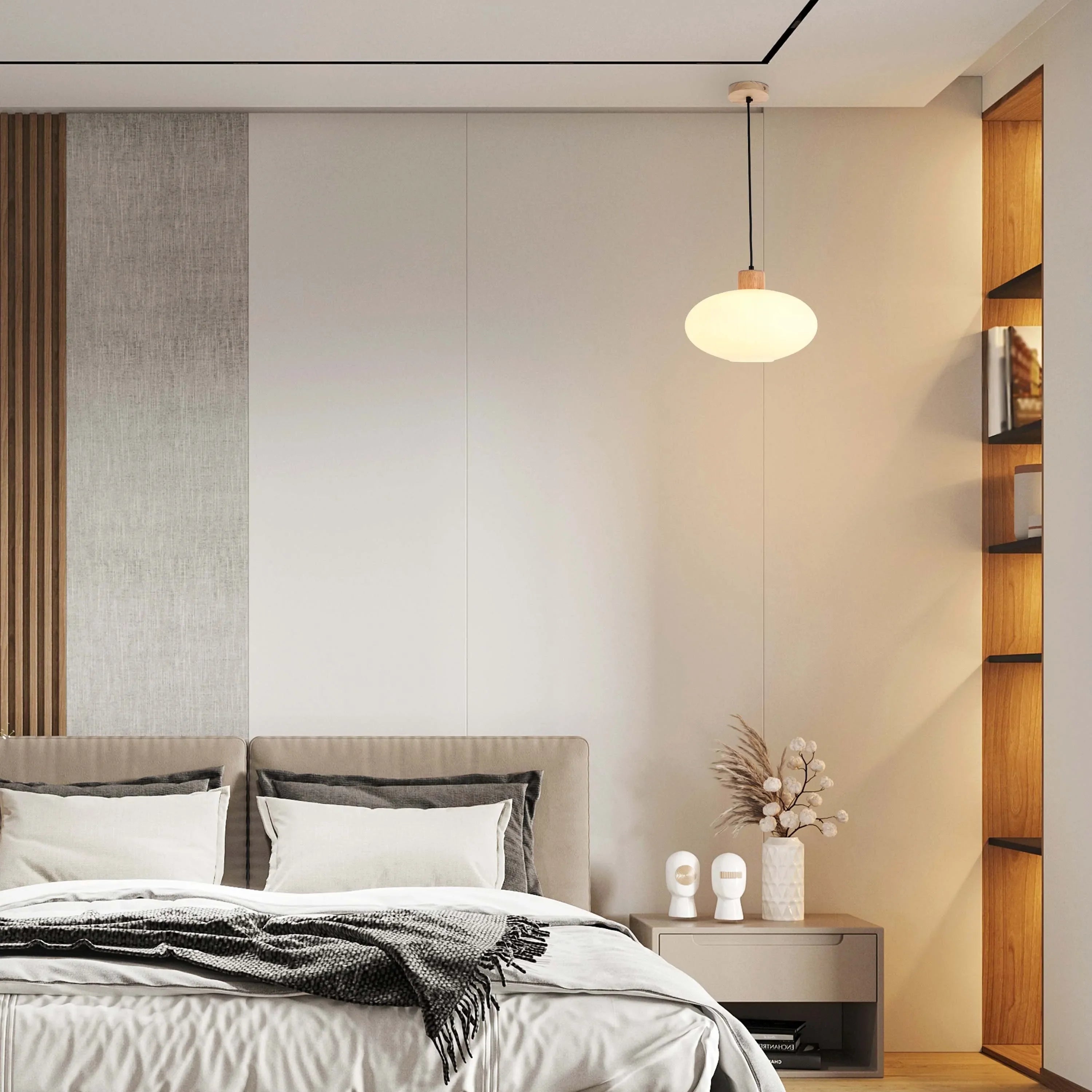 A pendant light hangs above a bedroom. The warm glow highlights a sleek, minimalist design, adding a touch of cosiness to the space.