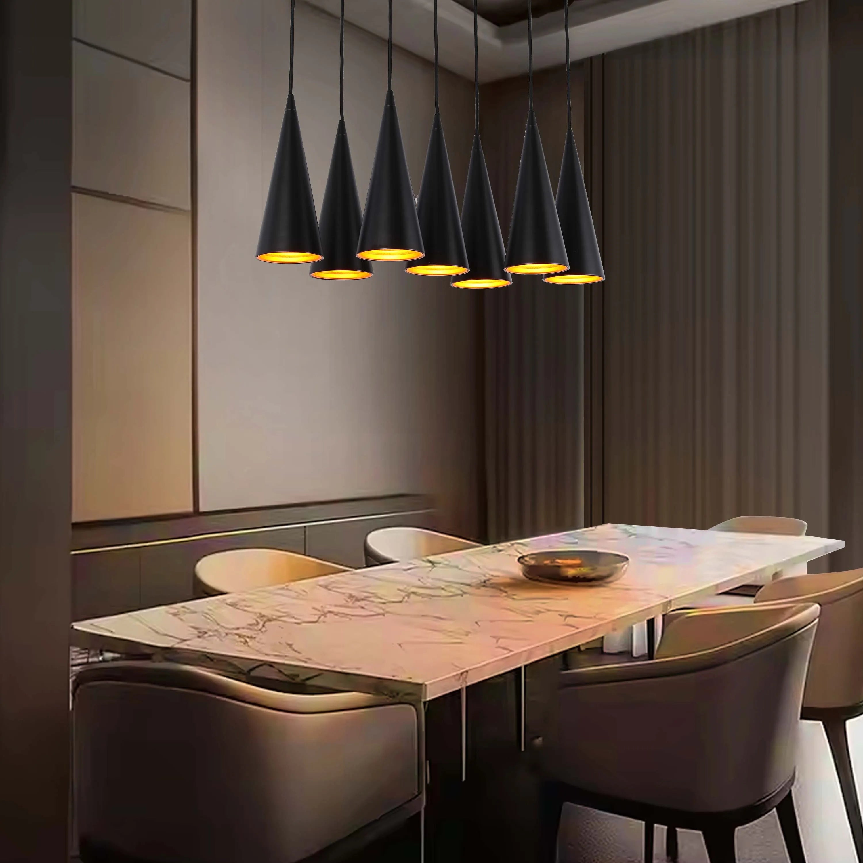 A row of seven black cone-shaped pendant lights hang above a dining table, illuminating the room with a warm glow.