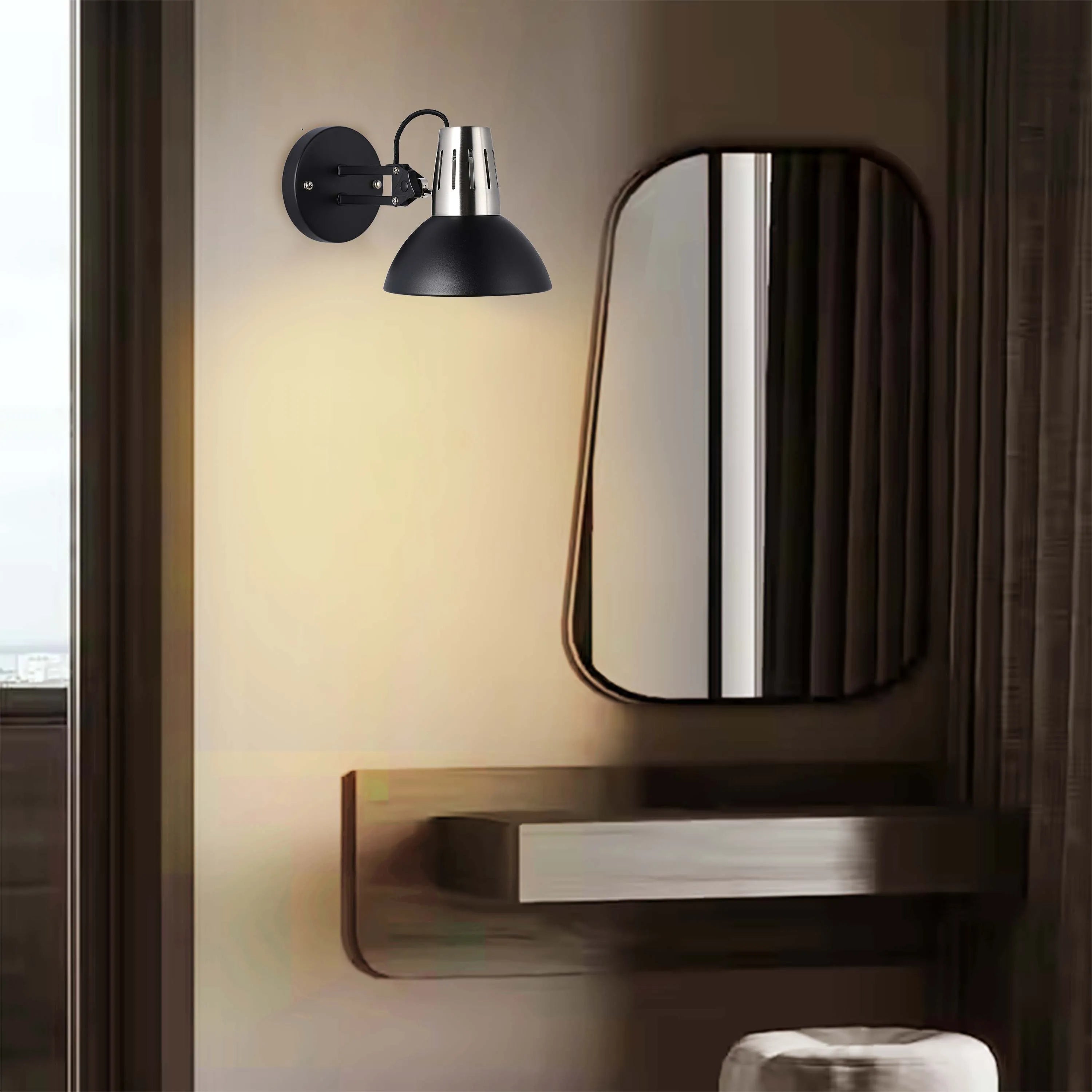 A black and chrome wall-mounted spotlight adds a touch of modern elegance to this dressing area. A warm, inviting glow is cast.