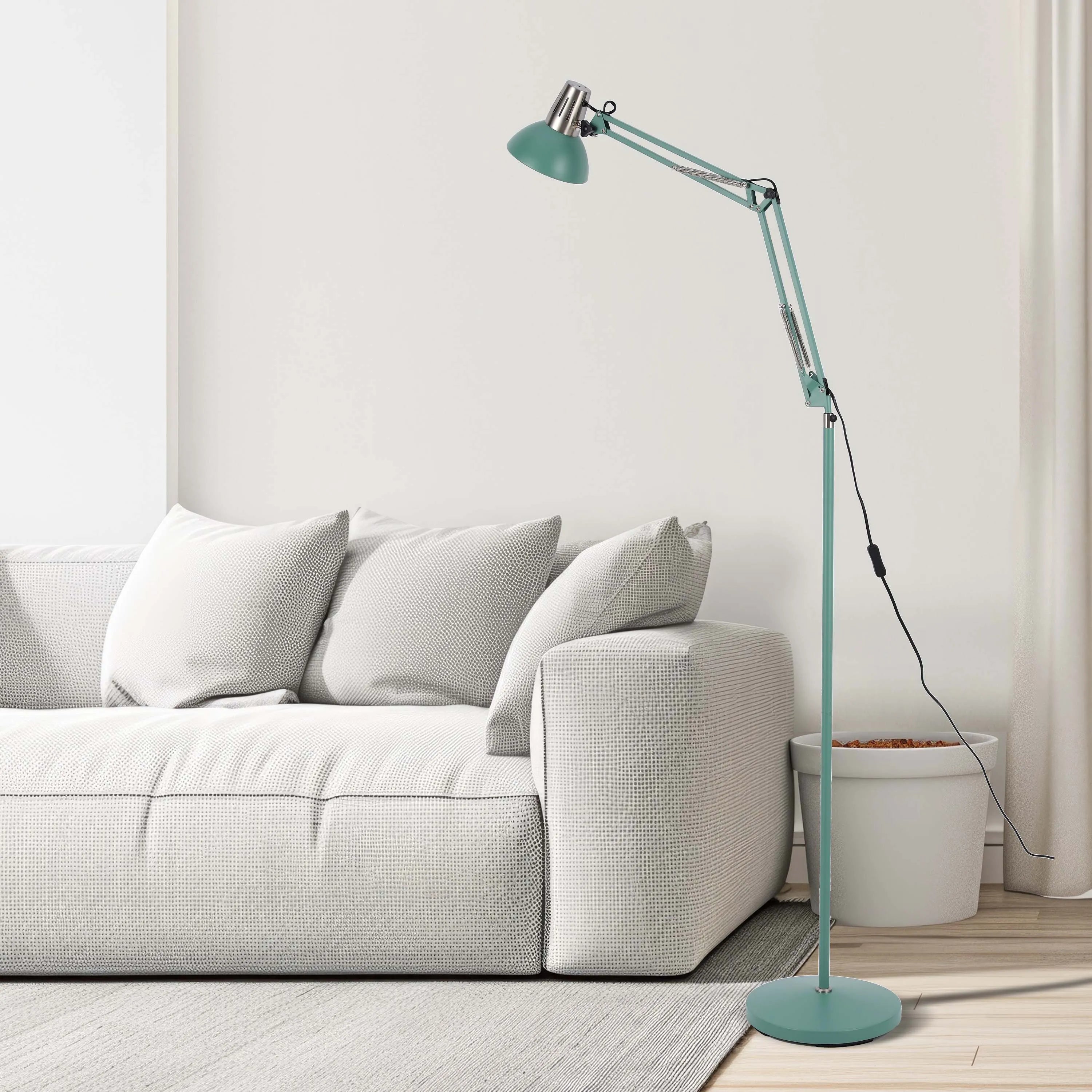 Stylish mint green floor lamp with an adjustable arm, casting a soft glow in a modern living room setting.