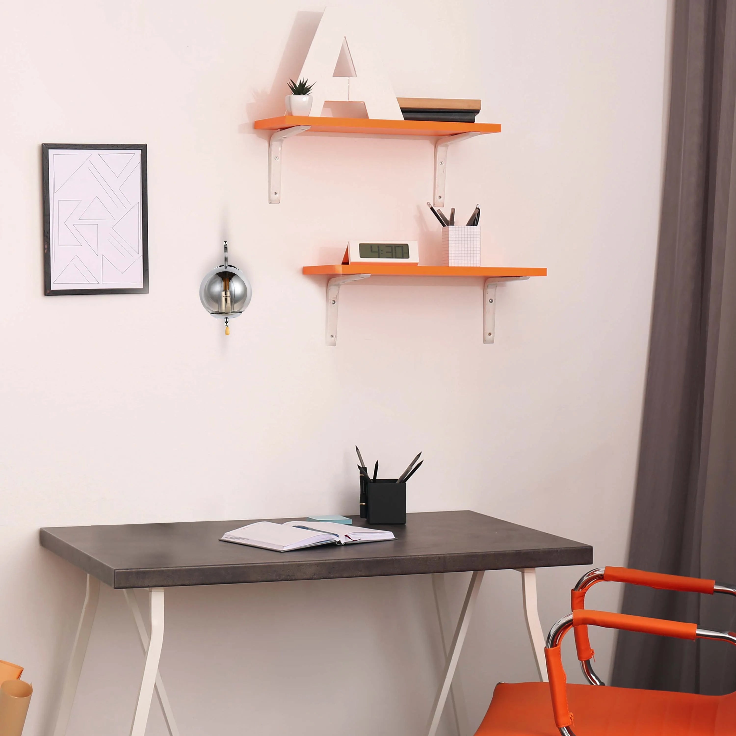 A room is illuminated by a sleek, globe-shaped wall light with a brushed silver finish, creating a modern ambiance.