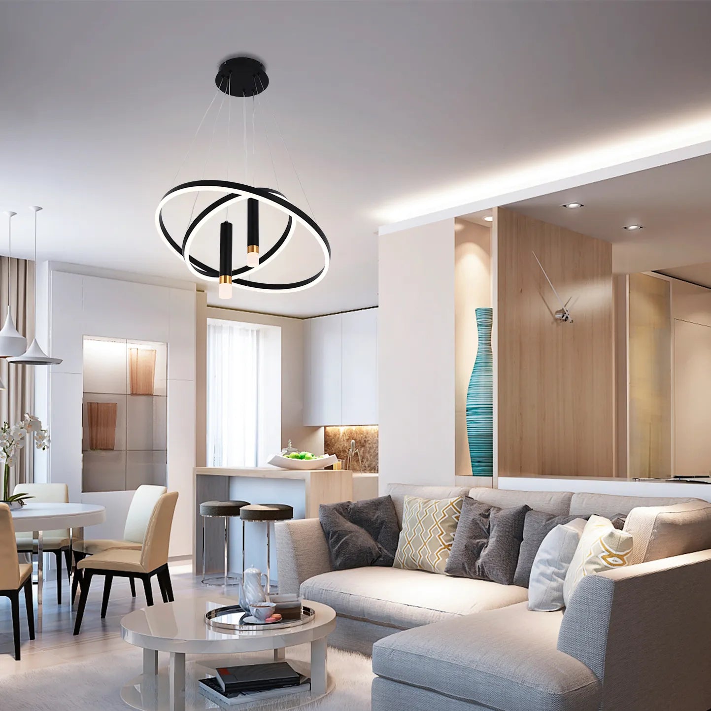A modern, circular chandelier illuminates the living space, hanging above the dining area with its sleek, minimalist design.