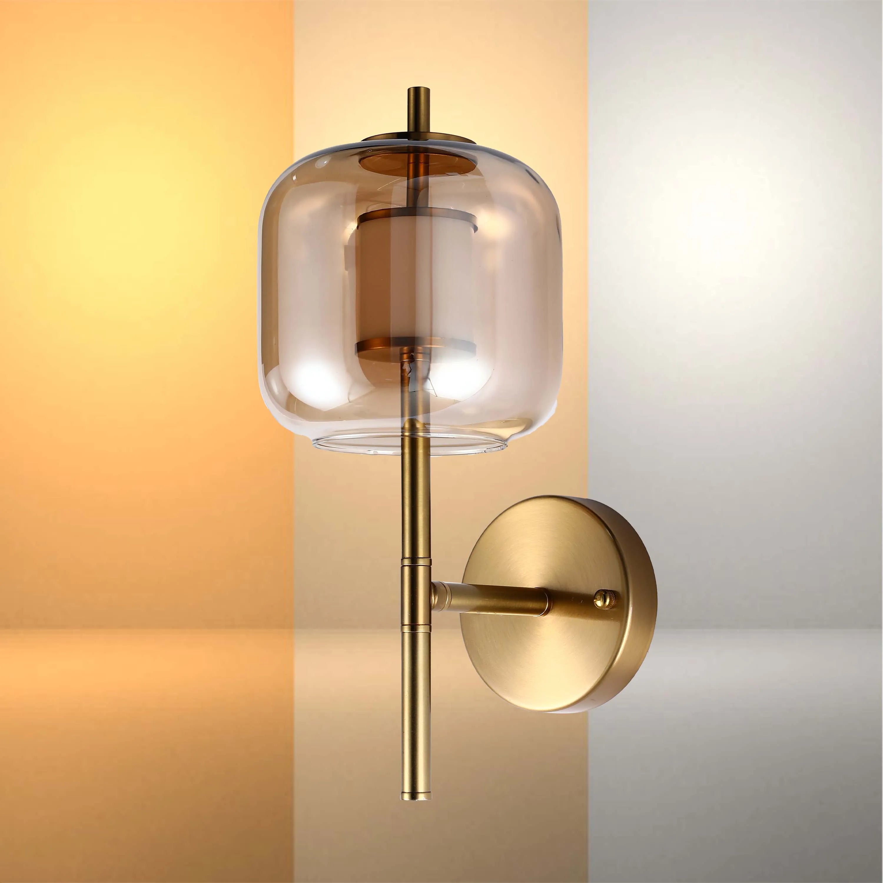 A gold and glass wall sconce emits a soft, elegant glow. Perfect accent lighting for any modern home.