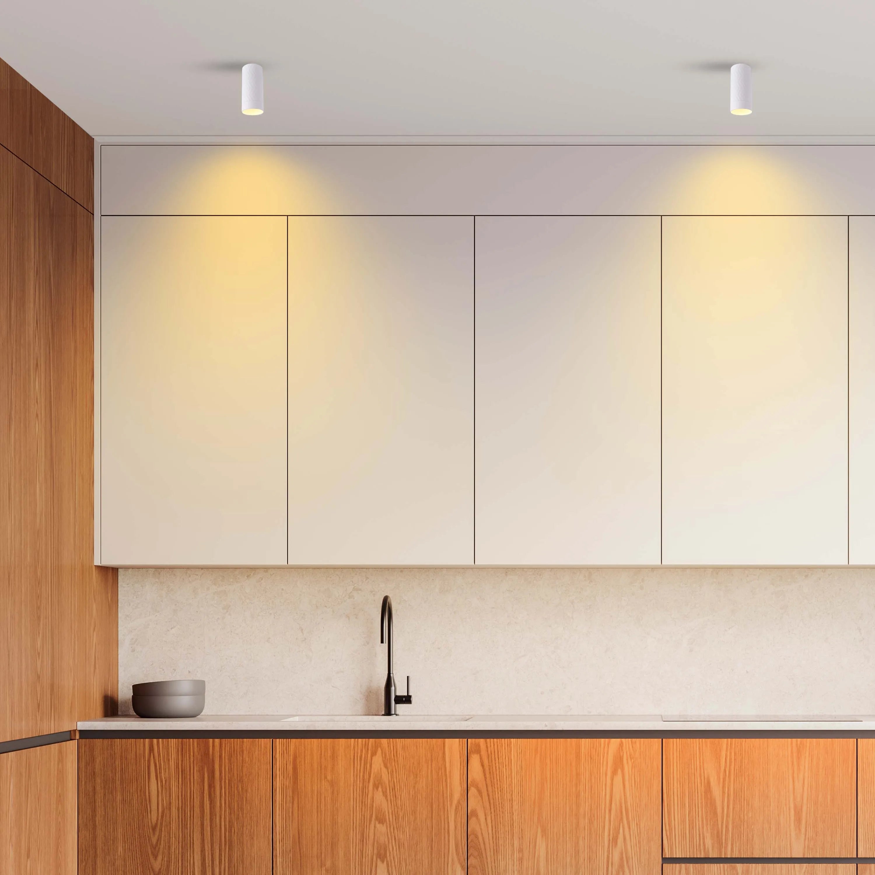 Kitchen with modern downlights illuminating the cabinets and work surfaces, providing a bright and welcoming atmosphere.