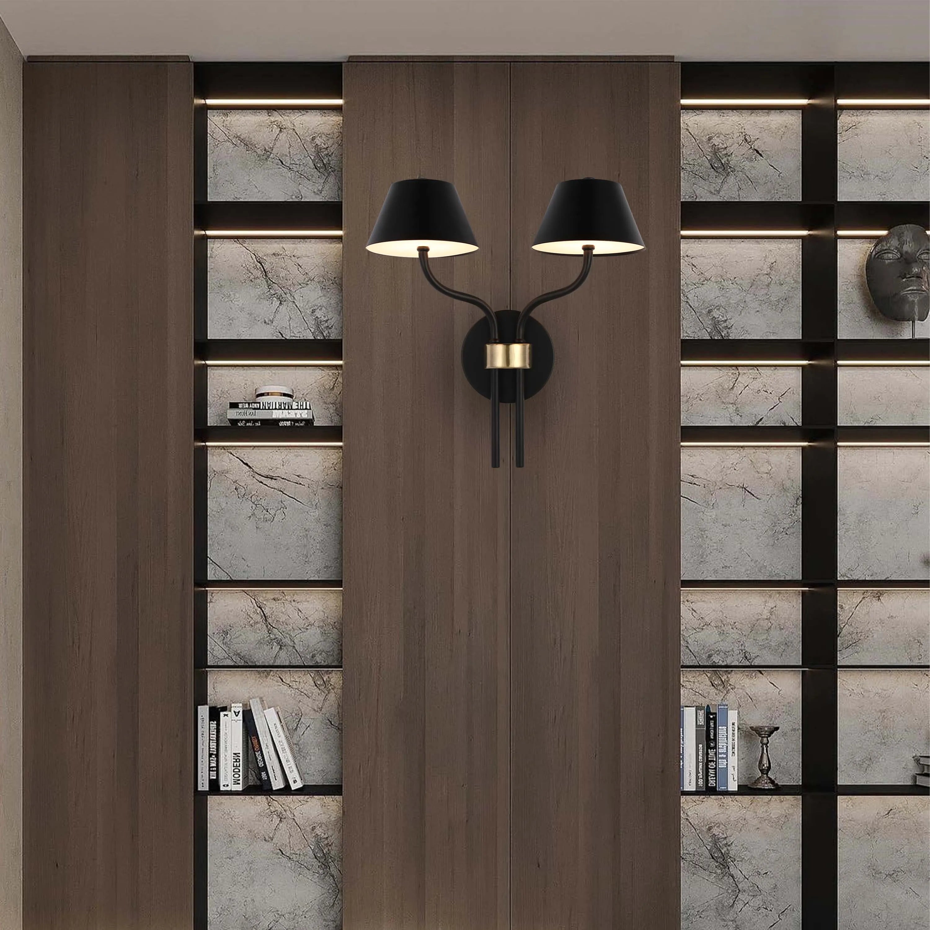 A statement wall light with a black finish and two lamps shines between wood cabinets and shelves, creating a warm, modern ambience.