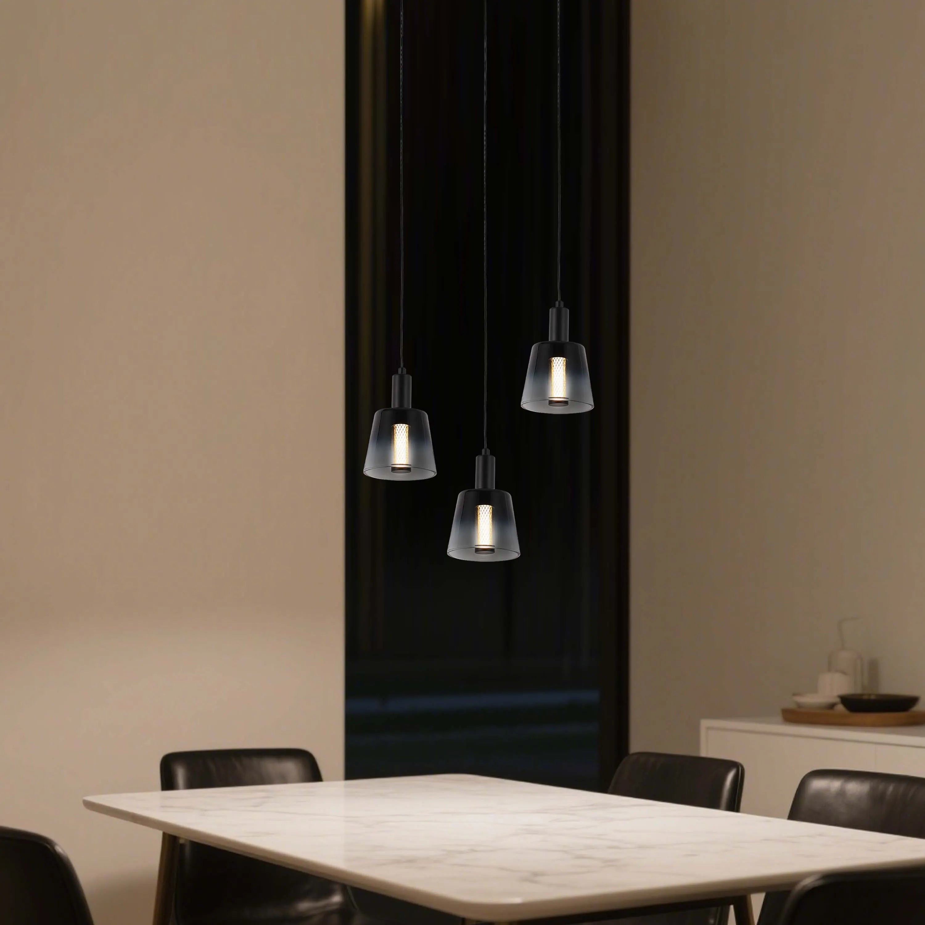 Contemporary pendant lighting featuring three glass shades with a soft, downward glow. Ideal for dining or kitchen areas.