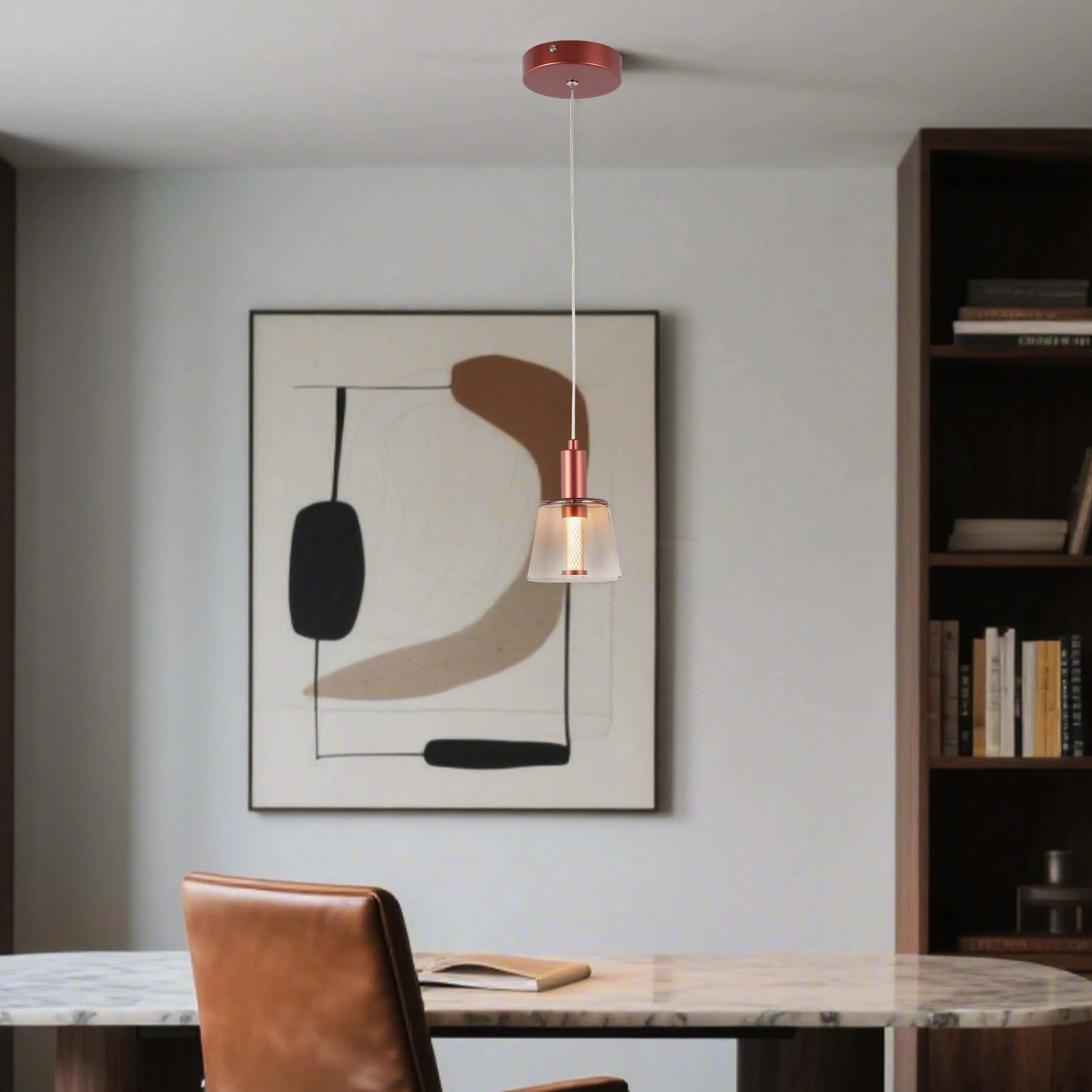 Copper pendant light over marble desk. Sleek design with a frosted glass shade complements the modern office decor.