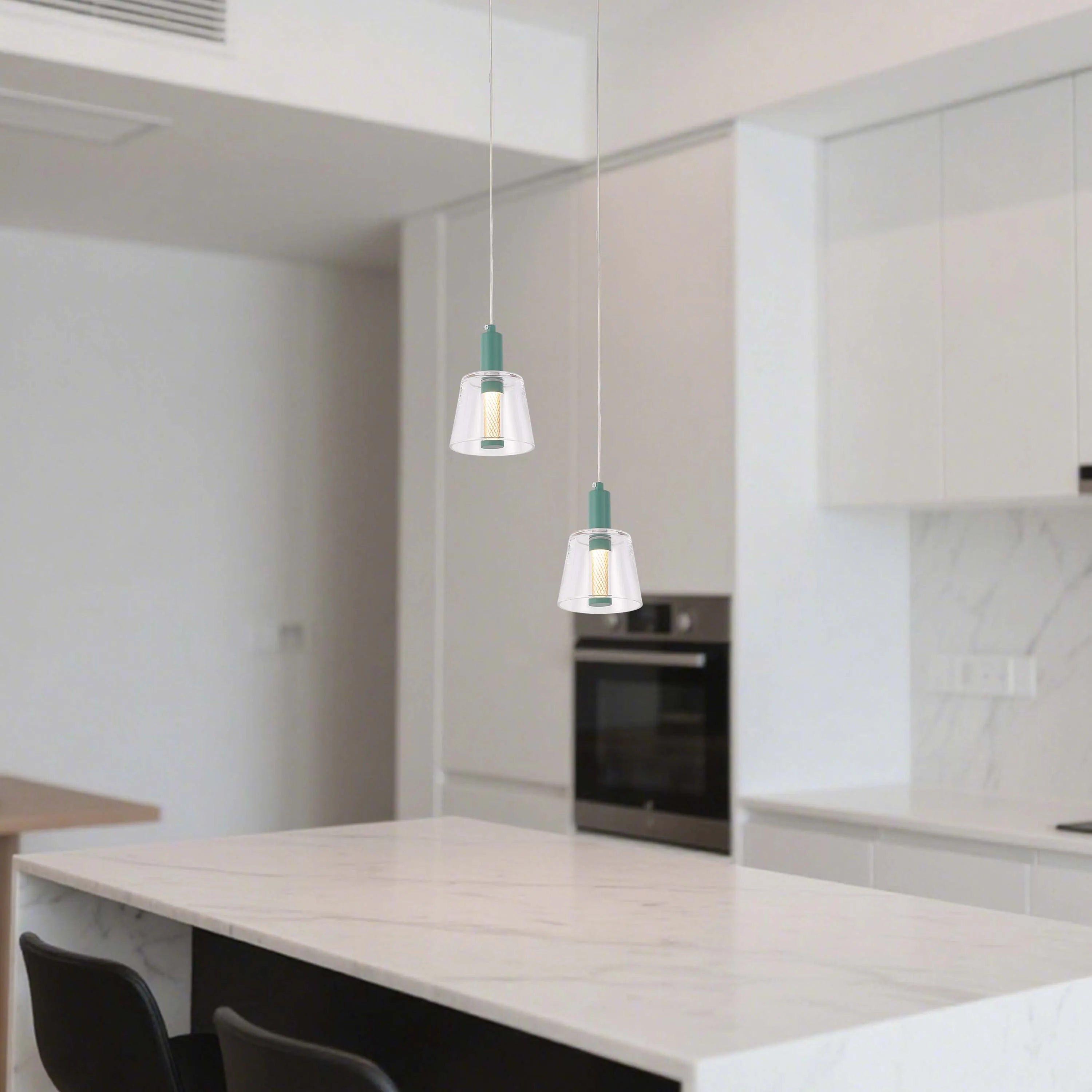 Two stylish pendant lights hang above a kitchen island, adding a modern touch to the minimalist design.