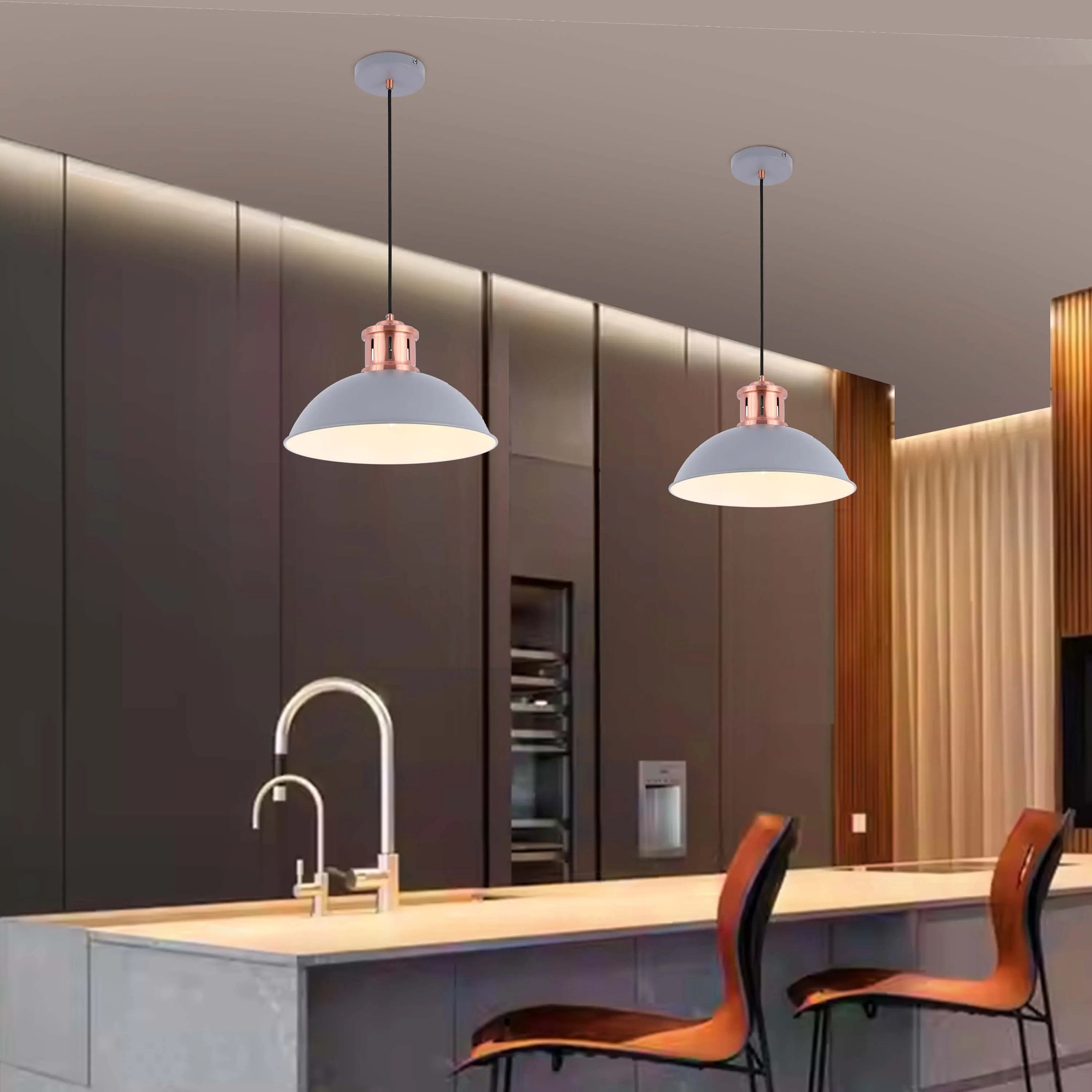Two grey pendant lights with copper accents illuminate a modern kitchen island, offering stylish task lighting.