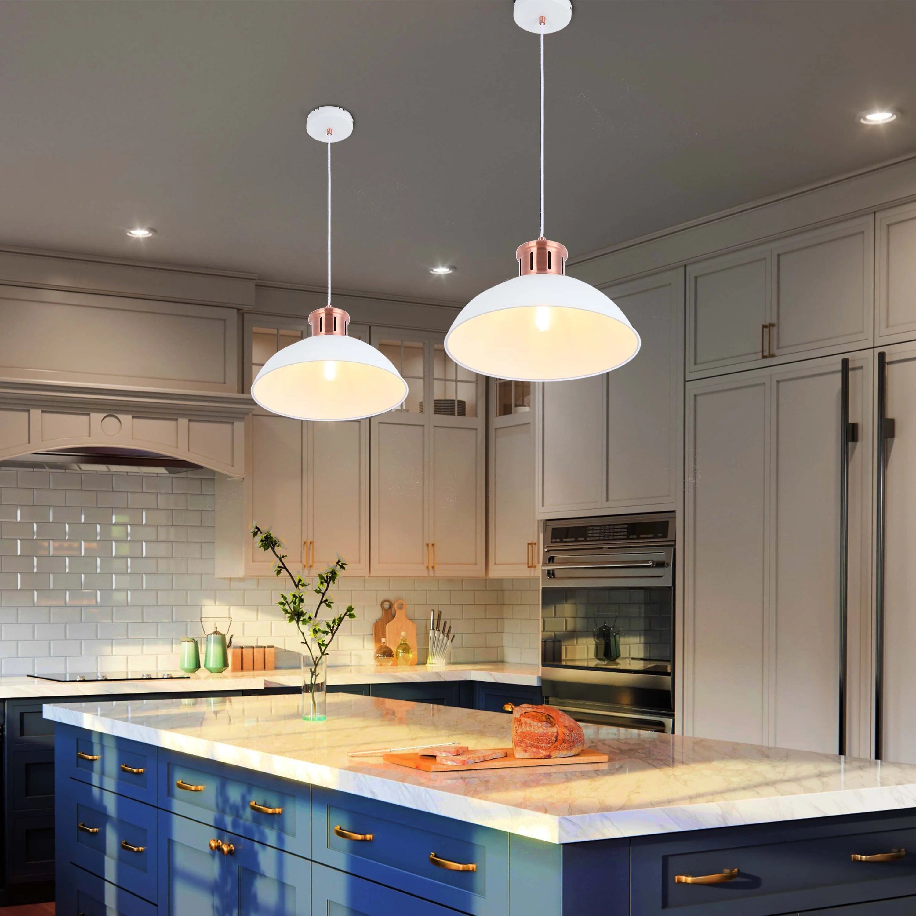 Two white and copper pendant lights hang above a kitchen island, illuminating the countertop with a warm glow.
