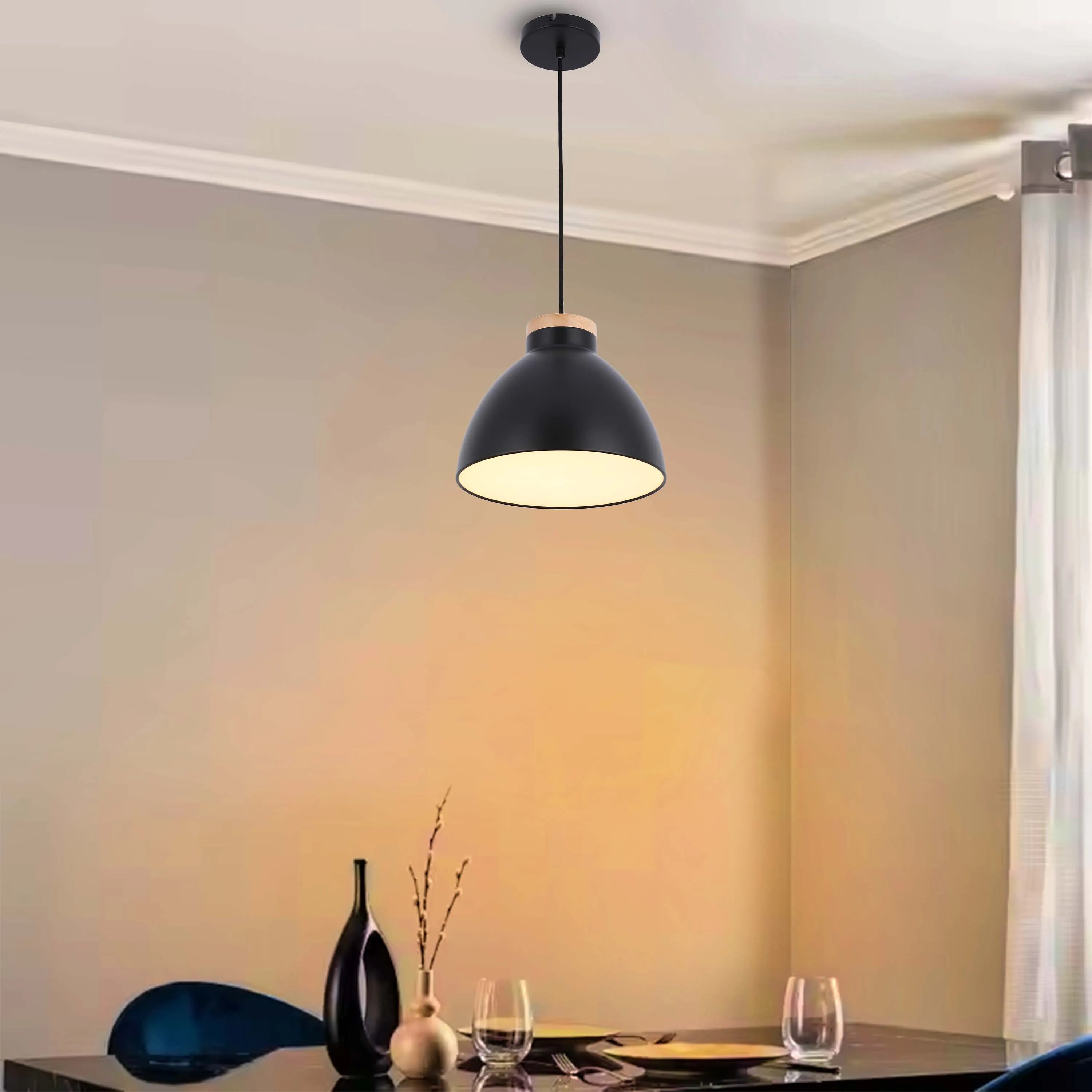 A black pendant light with a wooden accent hangs above a table, providing a bright and modern aesthetic to the dining space.