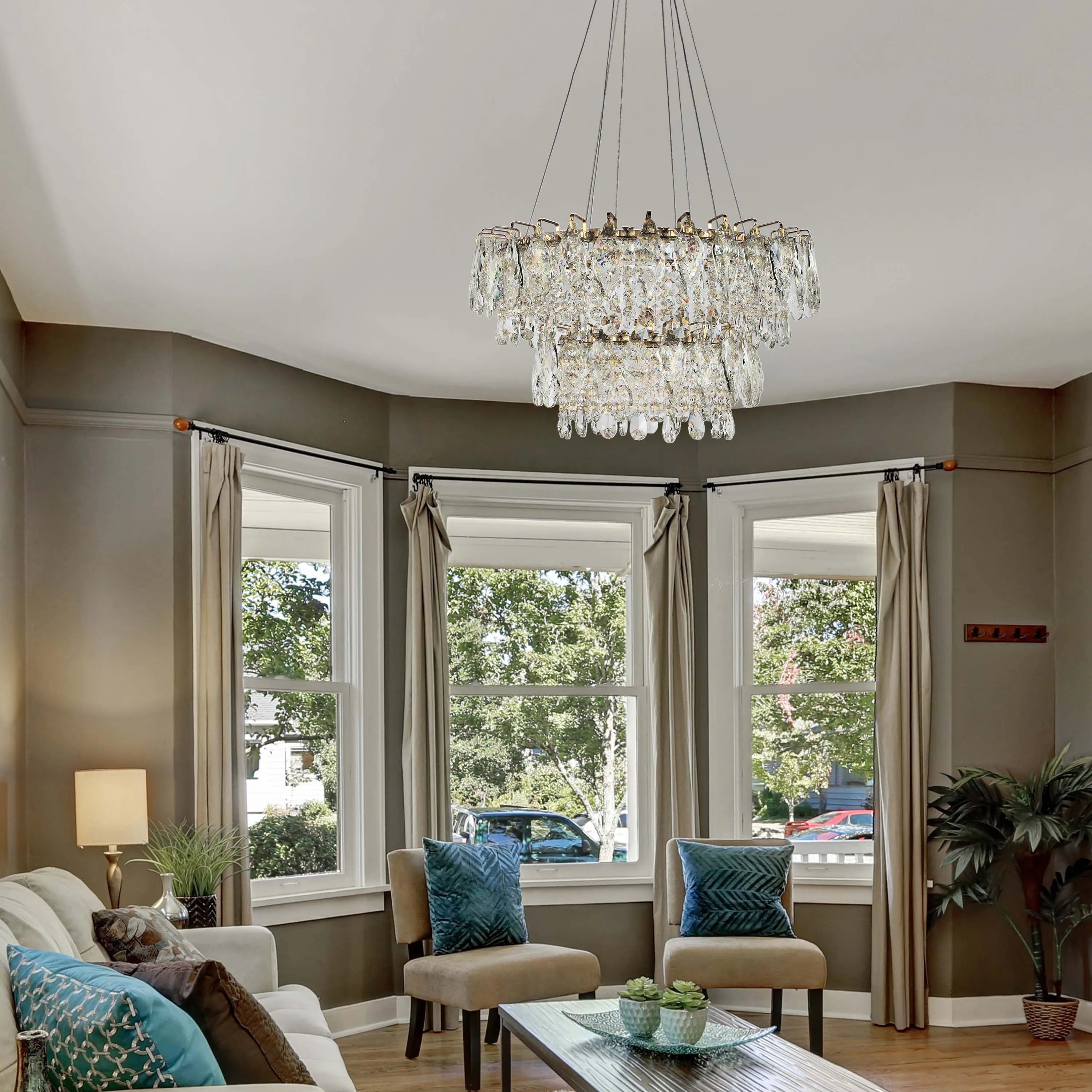 An ornate, tiered crystal chandelier illuminates a traditional living room, providing a glamorous focal point to the space.