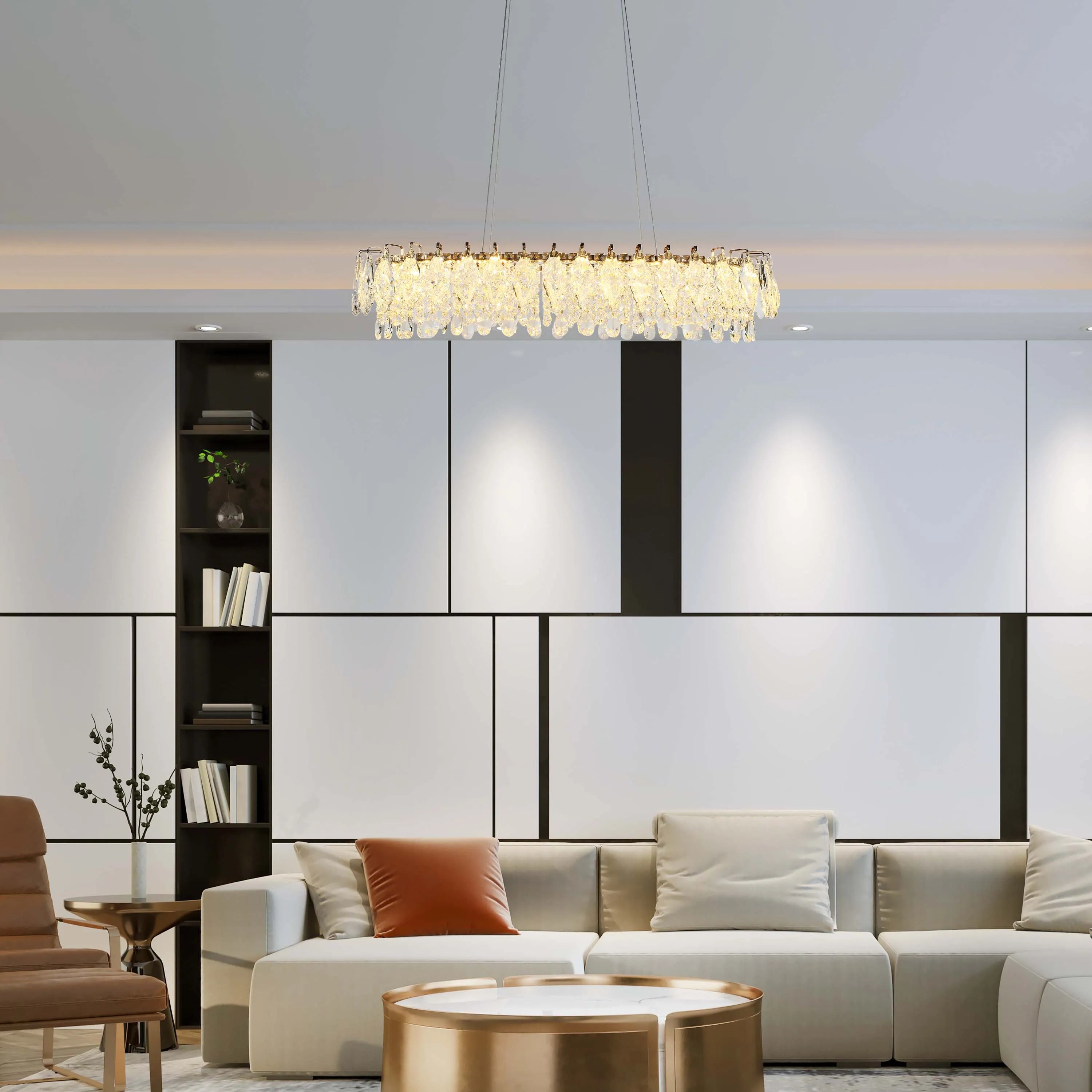 A modern living room with a crystal chandelier. Recessed lighting and lamps are also present, enhancing the overall ambience.