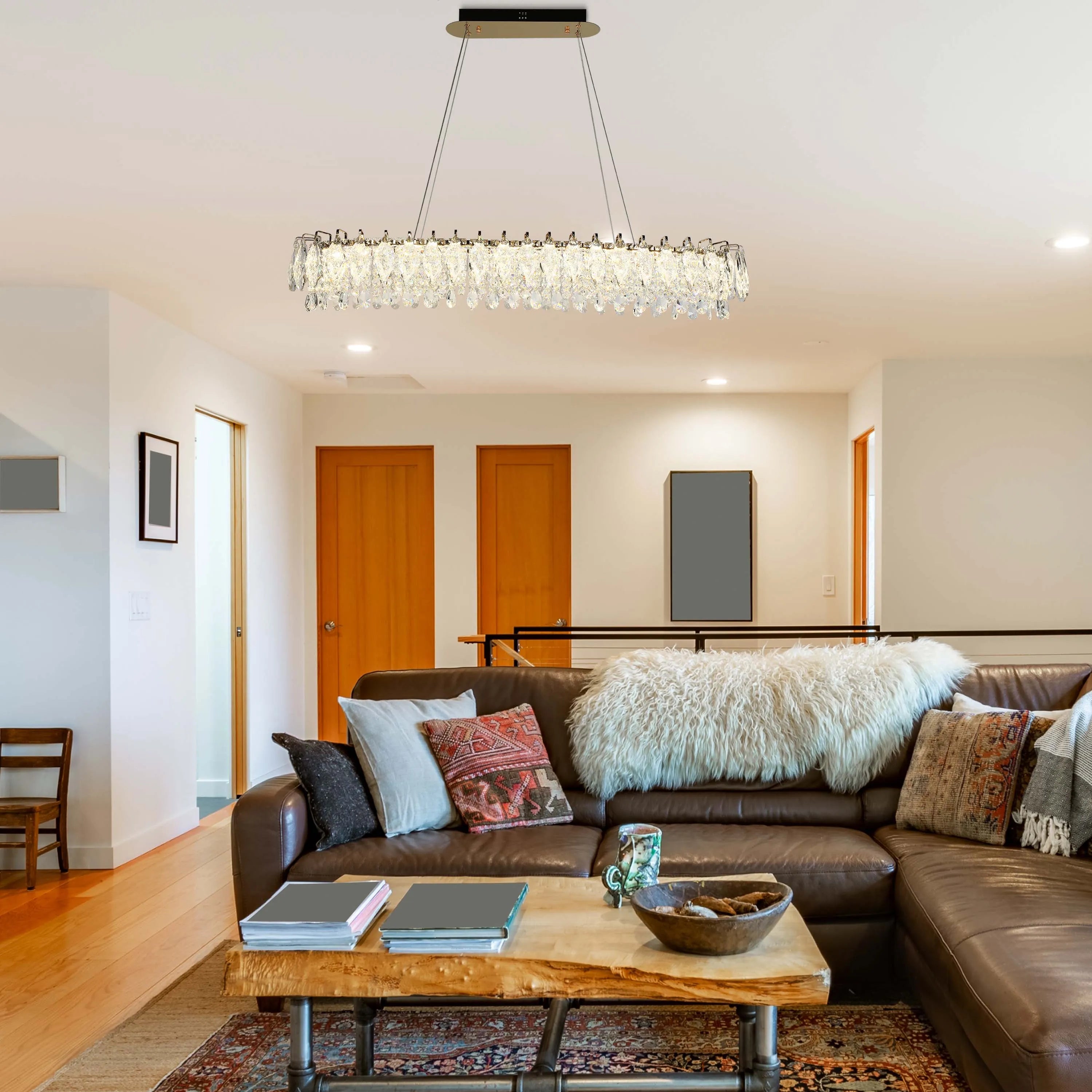 Contemporary rectangular chandelier with crystal droplets, suspended over a stylish living area. Modern and eye-catching lighting solution.
