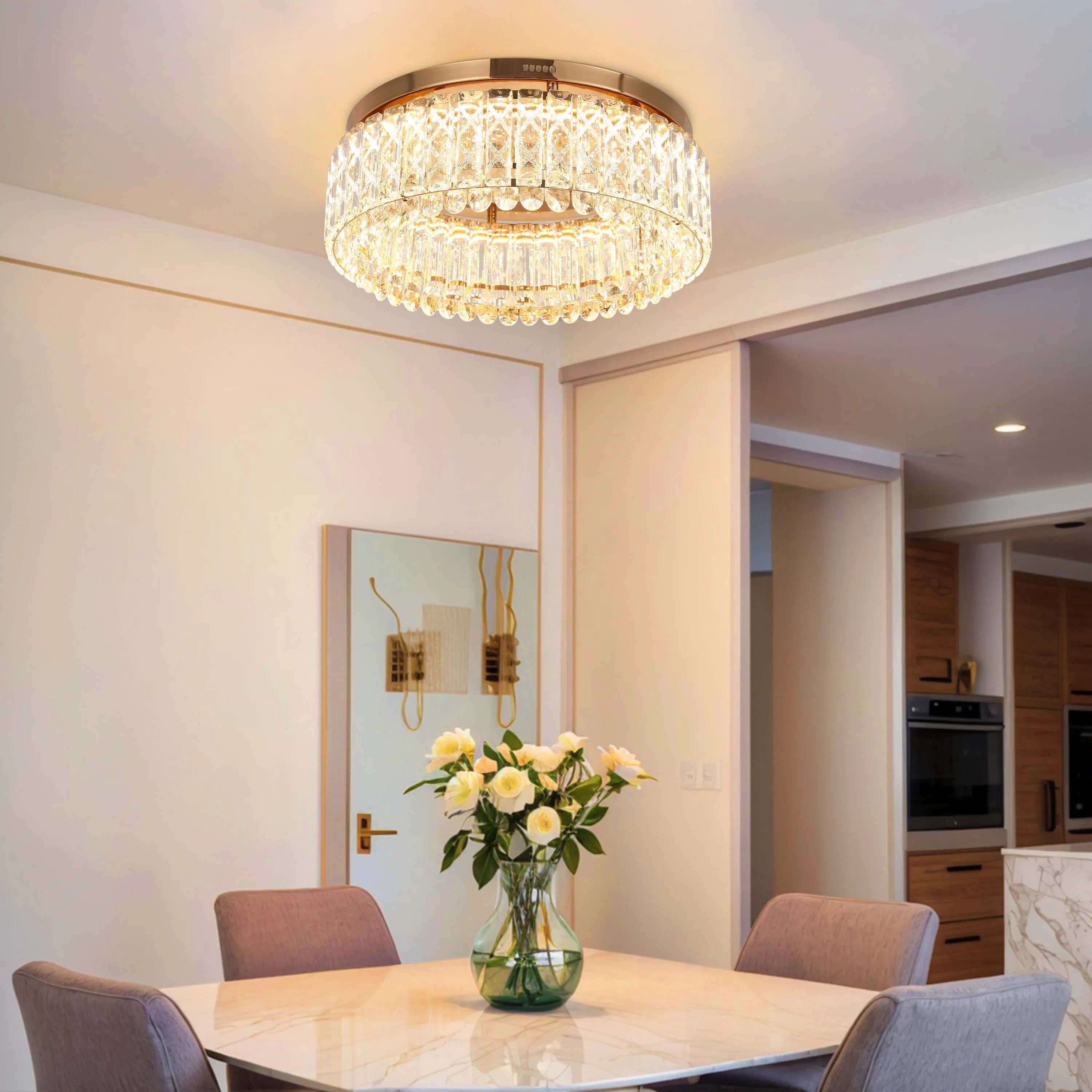 A modern, circular, crystal chandelier hangs in a dining room, creating a luxurious atmosphere.