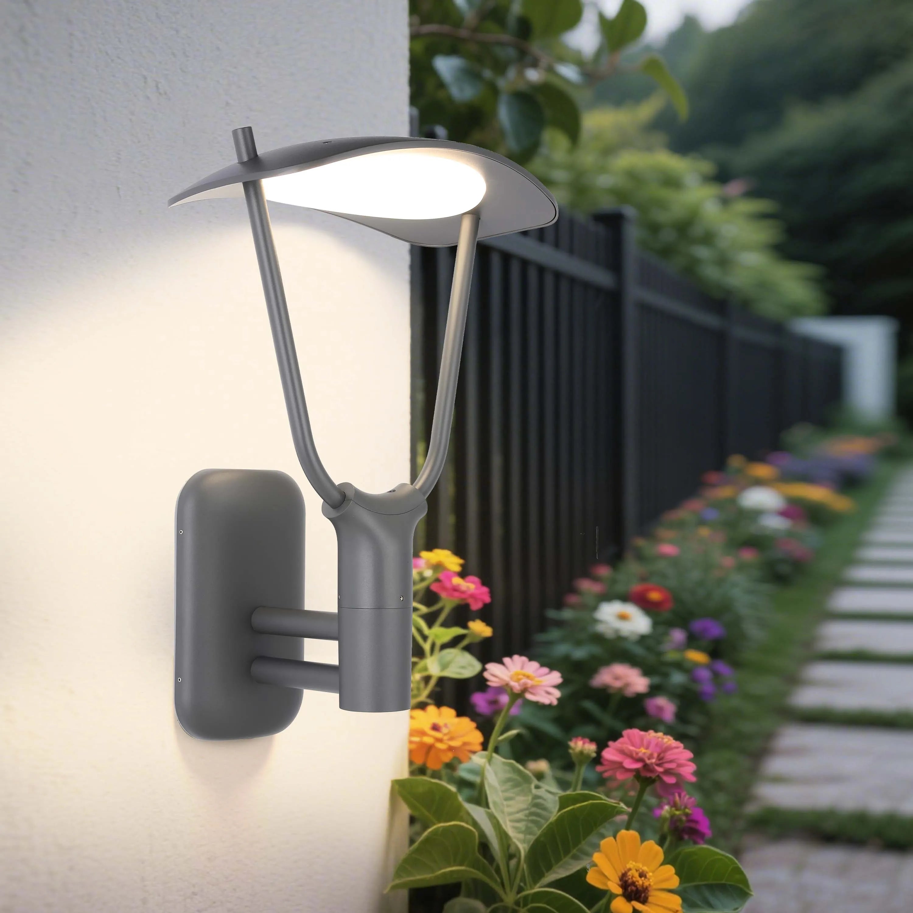 Modern outdoor wall light emitting a warm, inviting glow against a white rendered wall. Features sleek, contemporary design.