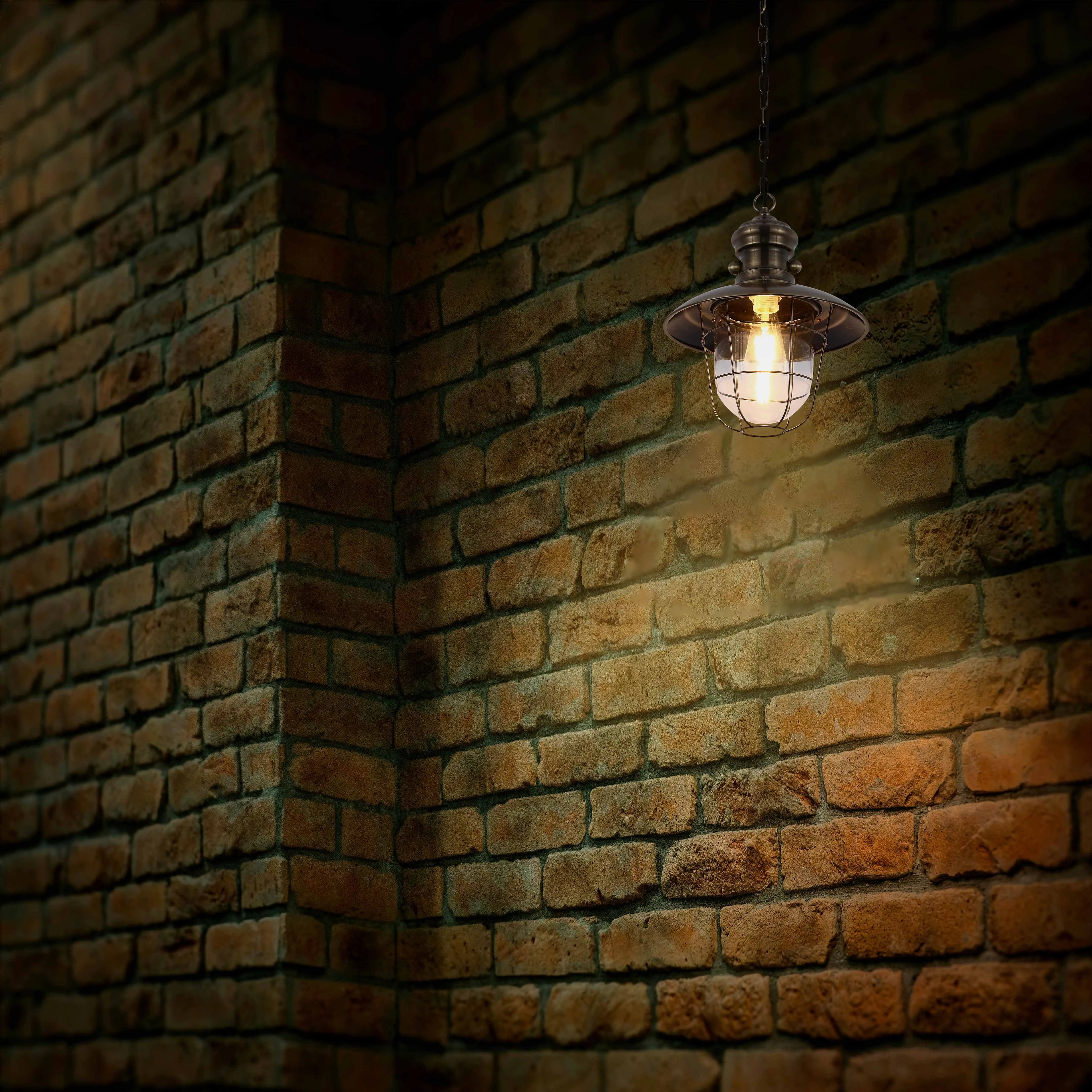 Warm, ambient lighting from a vintage-style hanging fixture highlights the rough texture of the brick wall, creating a cosy atmosphere.