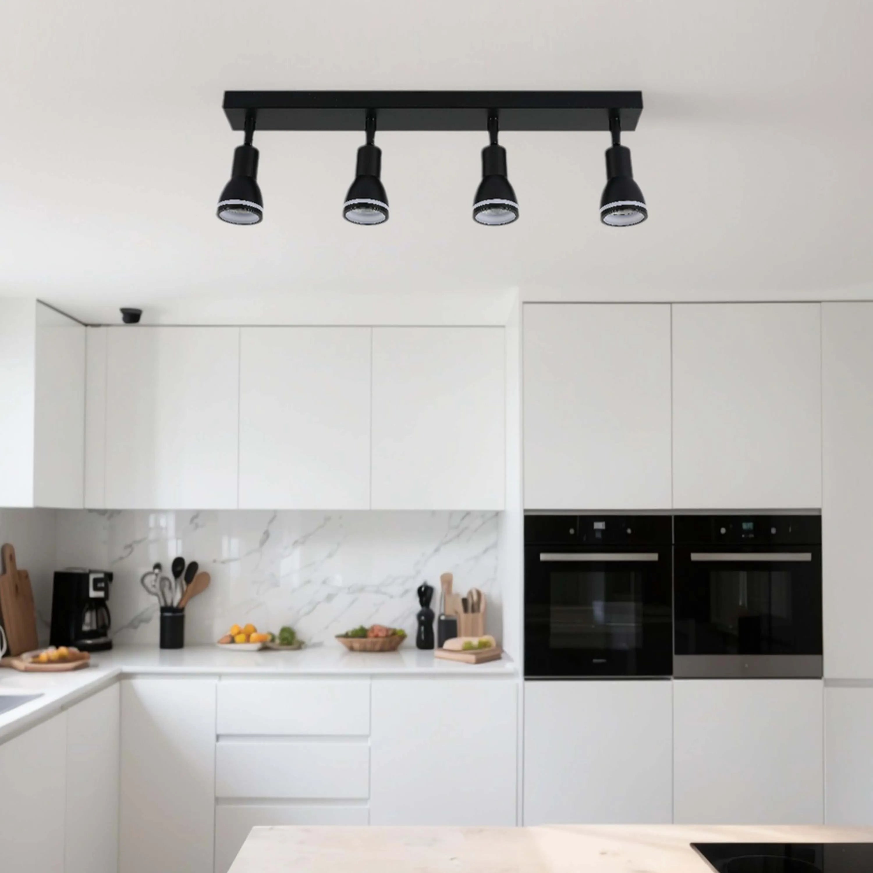 A modern kitchen with four black track spotlights mounted on the ceiling. Provides bright and directional lighting.