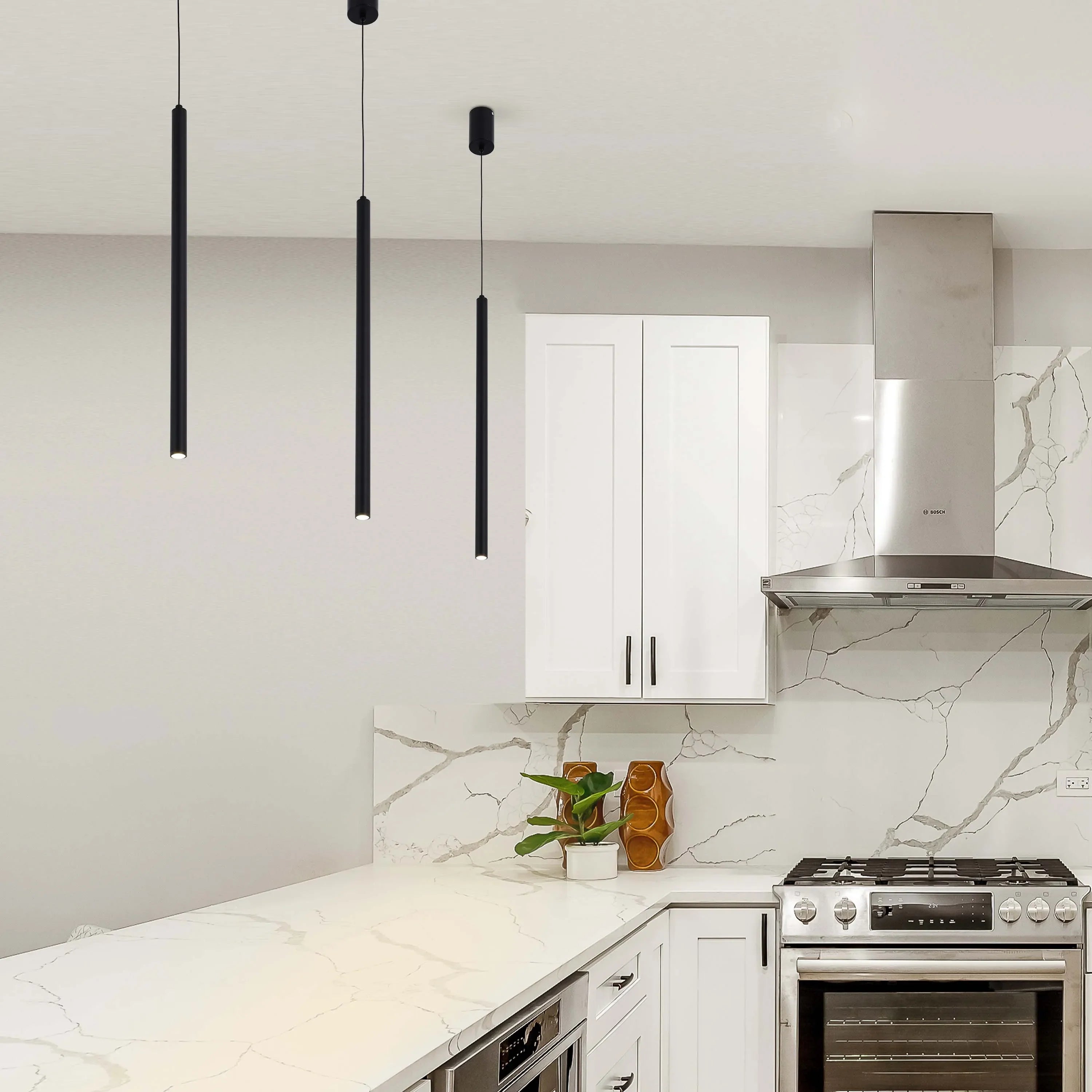 Contemporary kitchen with three black pendant lights hanging from the ceiling, providing focused and stylish illumination.