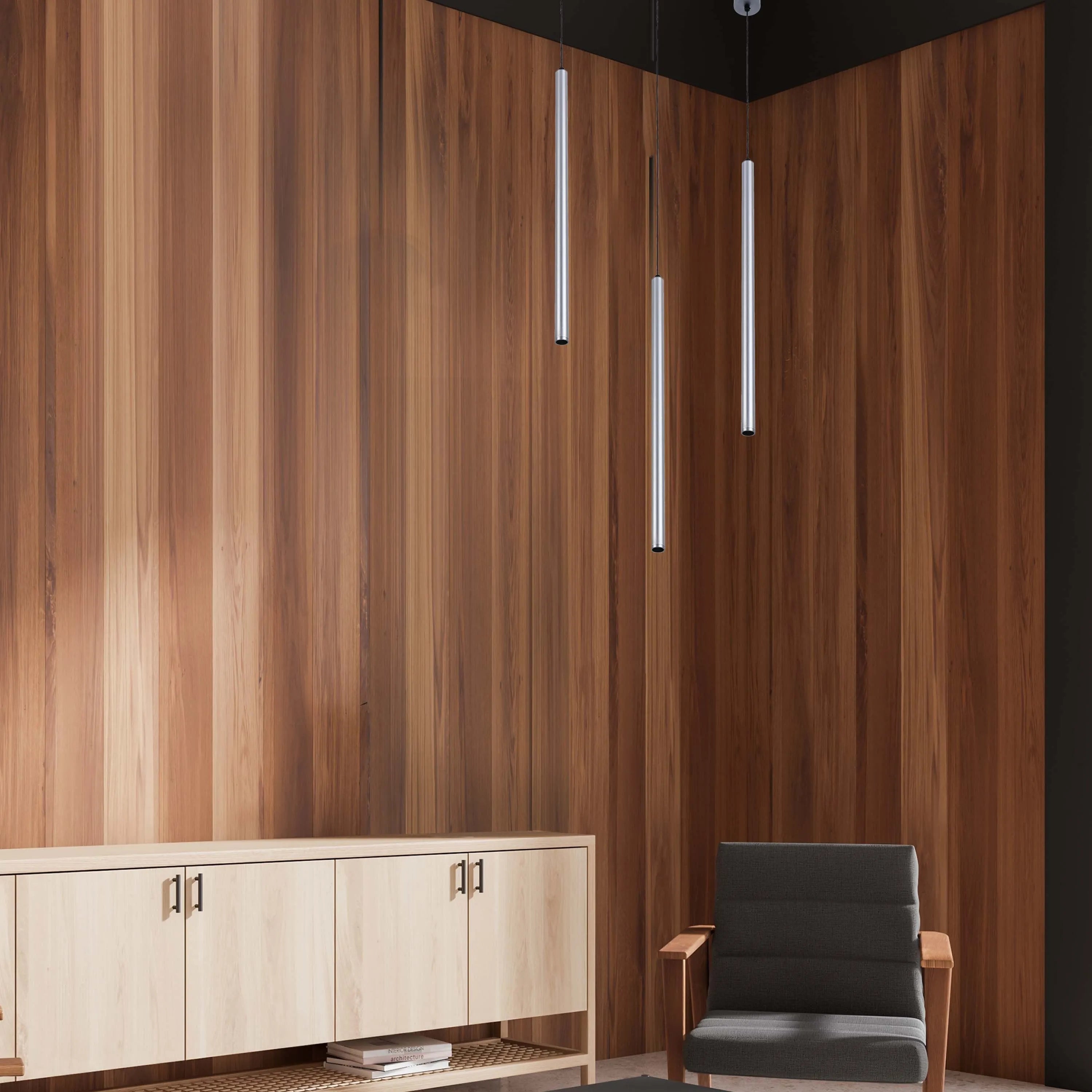 Three pendant lights hang from a dark ceiling. The lights are cylindrical and silver, adding a modern touch to the room.