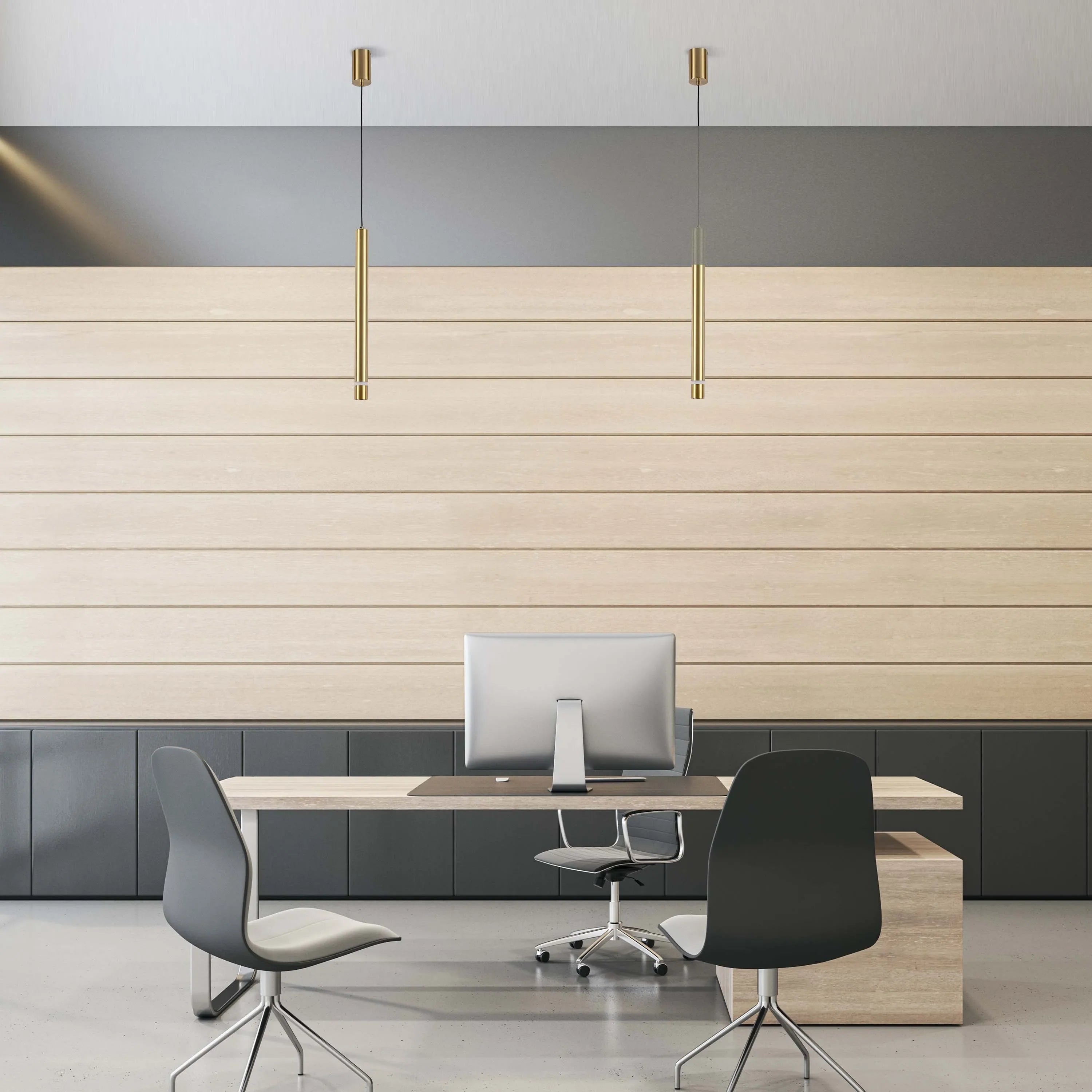 Modern office with pendant lighting. Two gold, cylindrical lights hang above the desk providing direct task lighting.