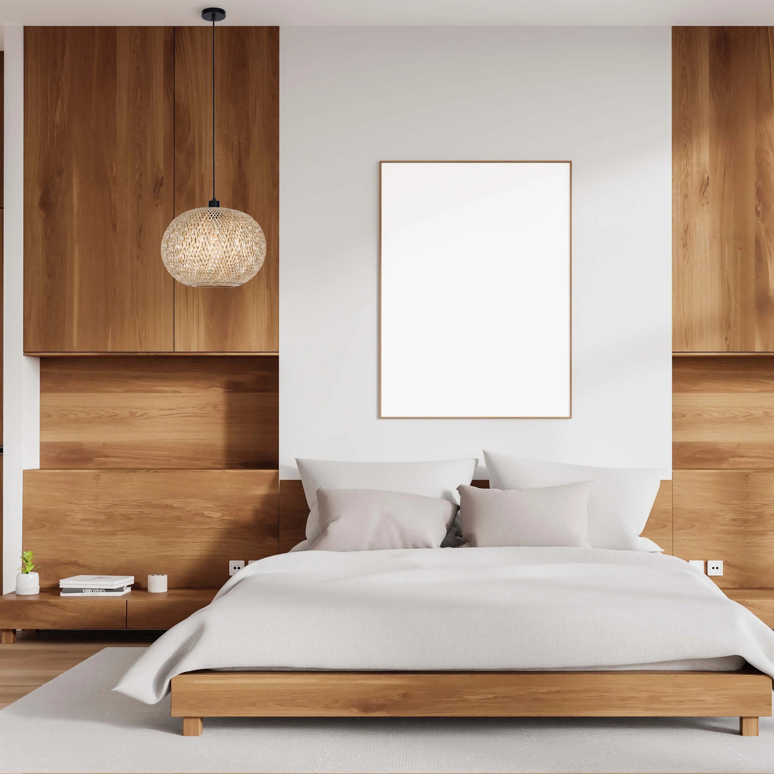 A wicker pendant light hangs above a stylish bedroom, casting a warm glow on the wood and white colour palette.