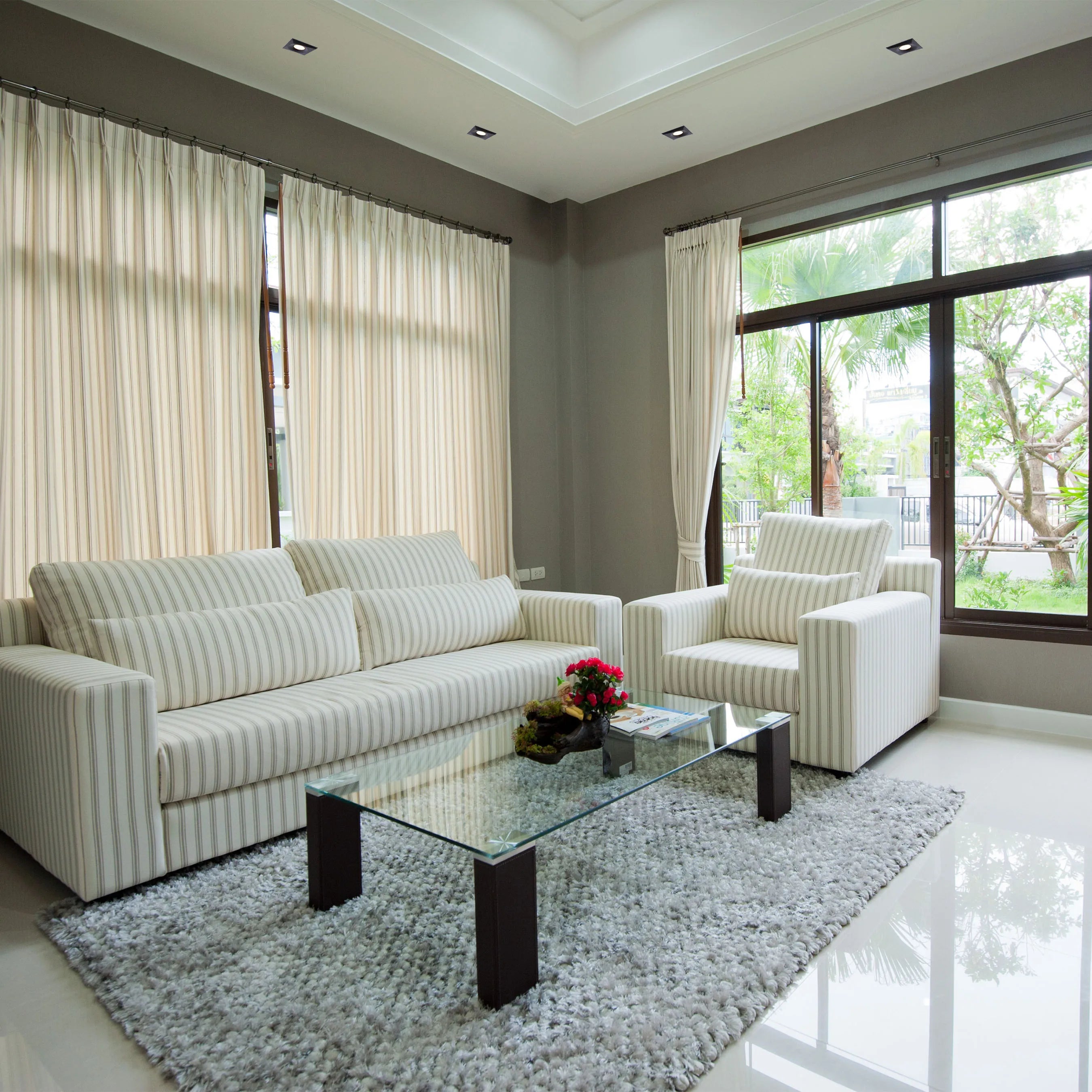 Recessed downlights provide ambient lighting in this living room, creating a bright and modern space.