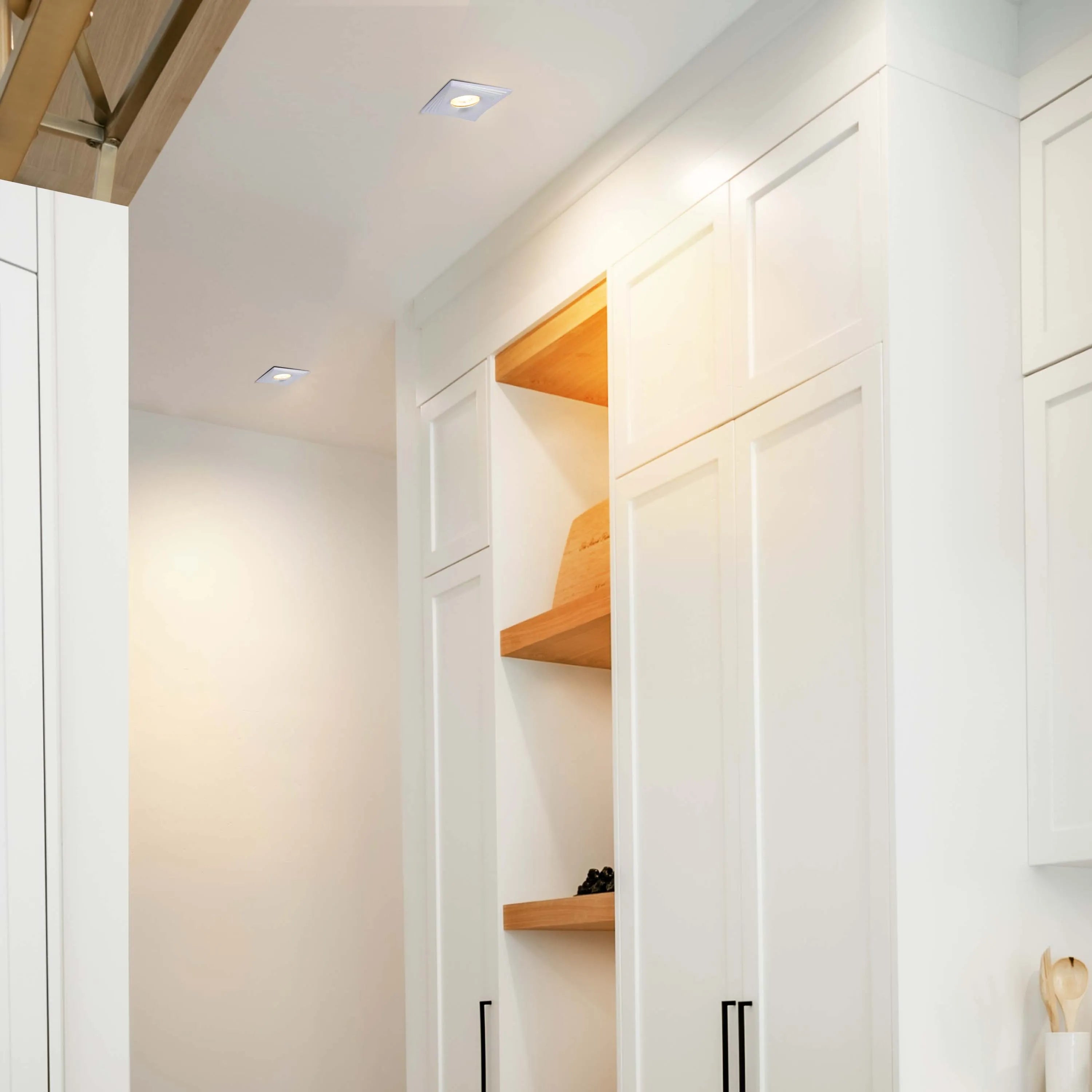 Modern kitchen with sleek, recessed lighting. Square downlights are flush with the ceiling, providing bright, even illumination.