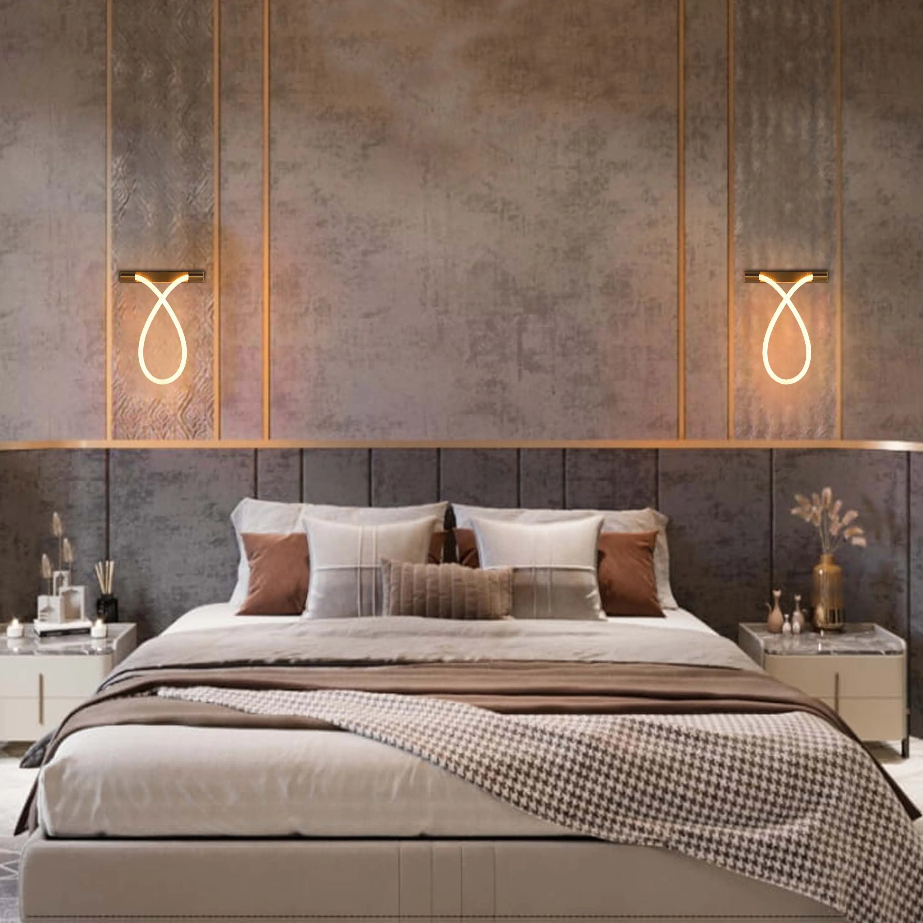 Elegant wall sconces emit a warm glow, adding a modern touch to this luxurious bedroom's ambient lighting.