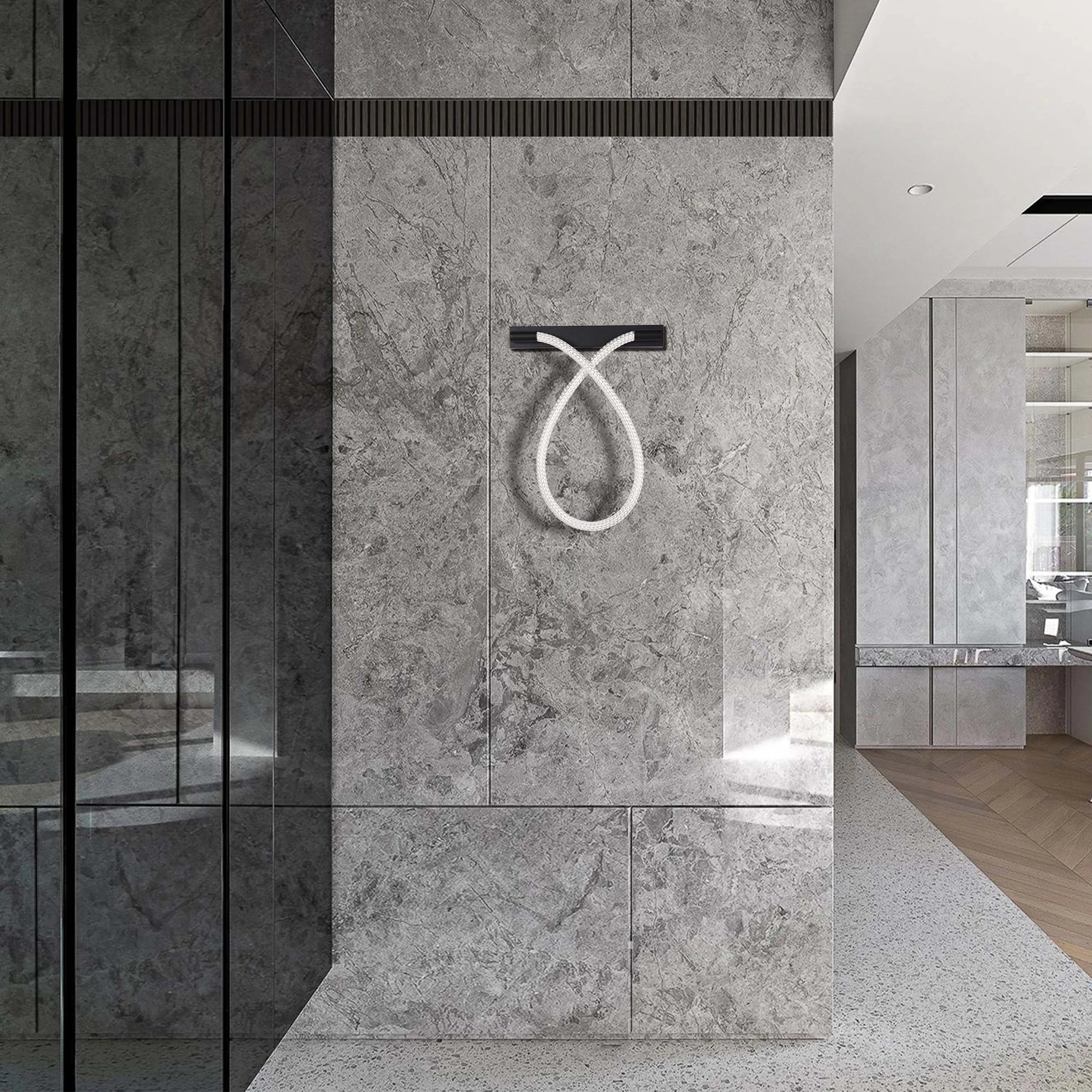 Modern, sculptural wall light in the shape of an infinity symbol. Minimalist design and grey colour palette.