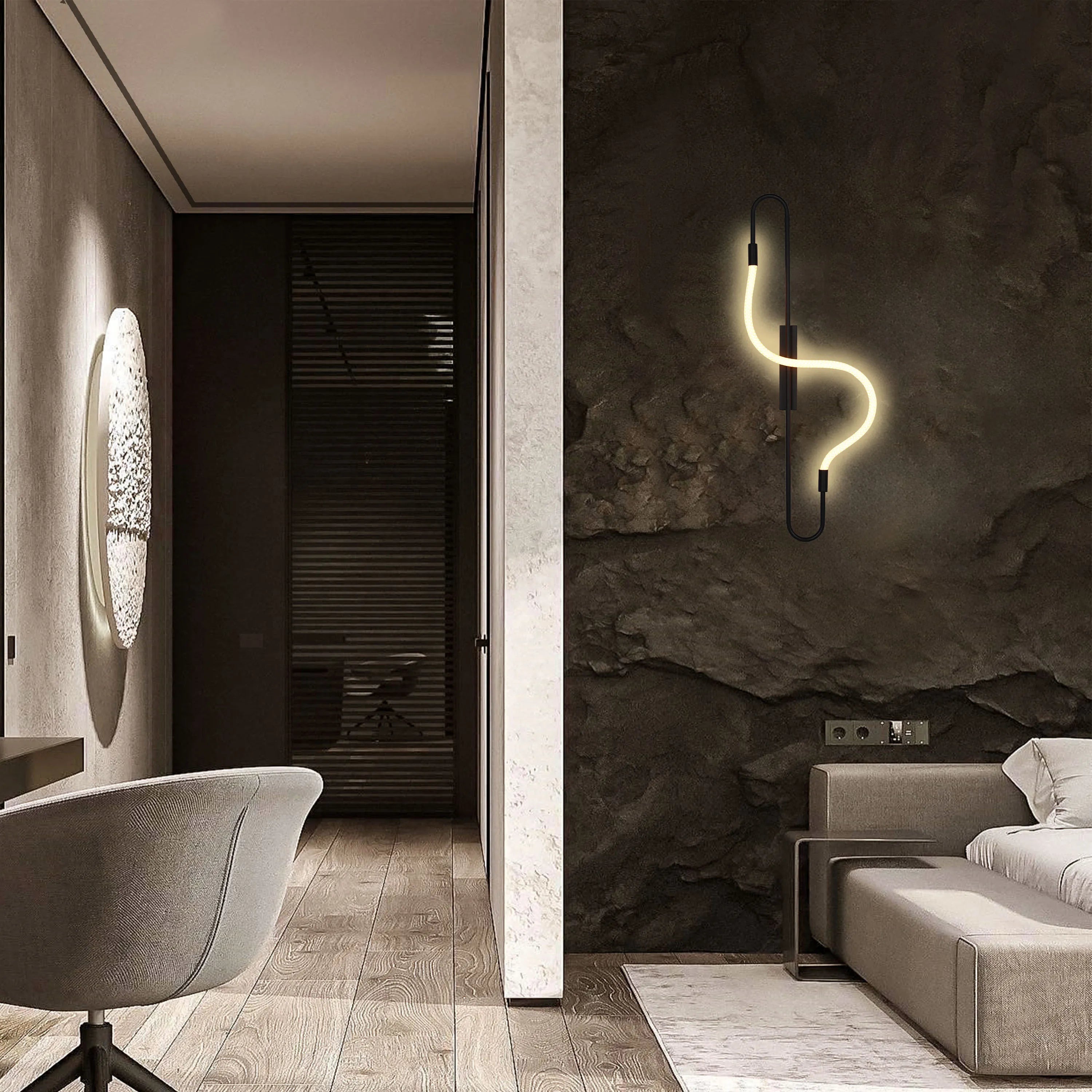 Stylish interior lighting featuring a wavy neon-style wall light and a modern, oval-shaped sconce.