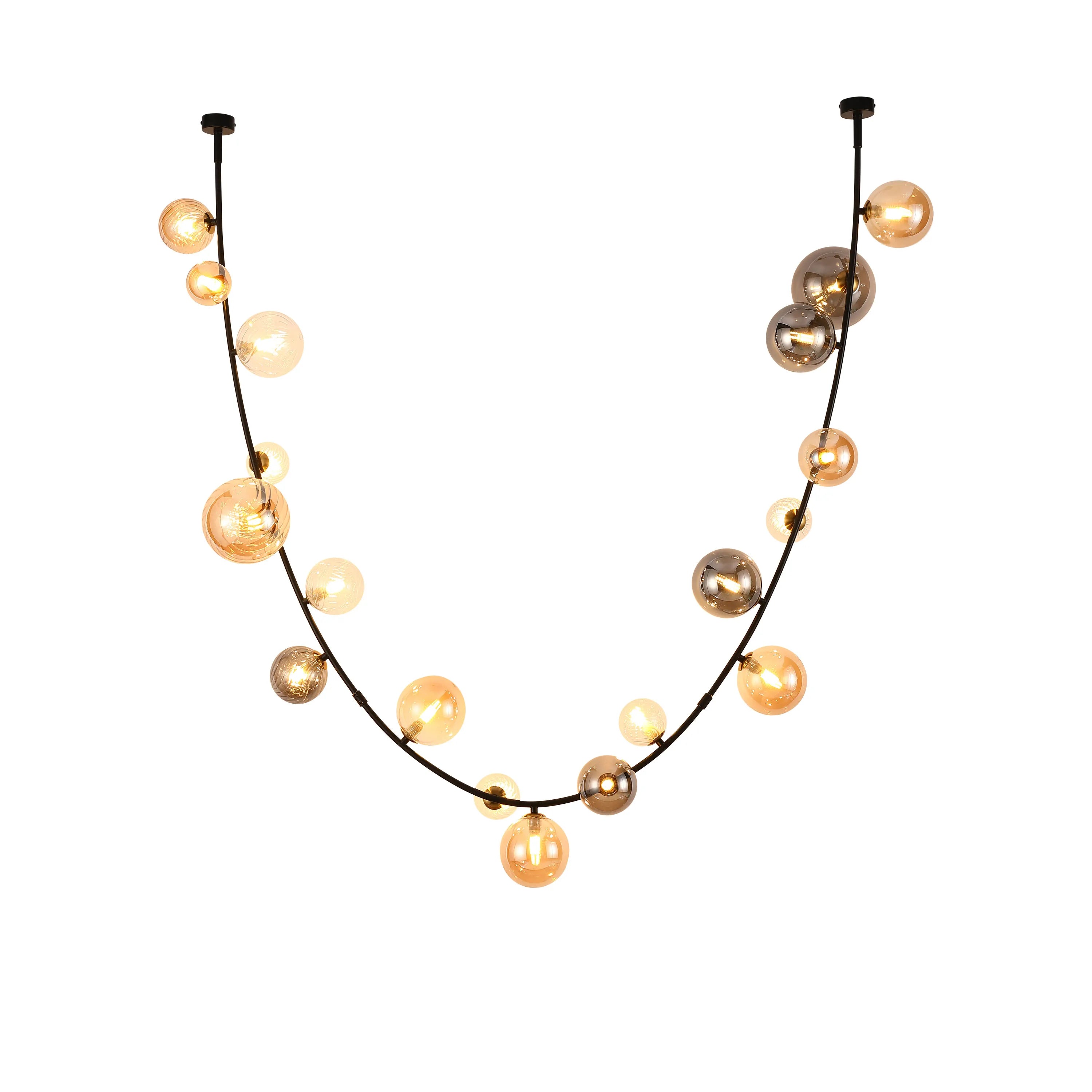 Modern black pendant light featuring glowing glass orb shades of amber and silver. Perfect statement lighting.