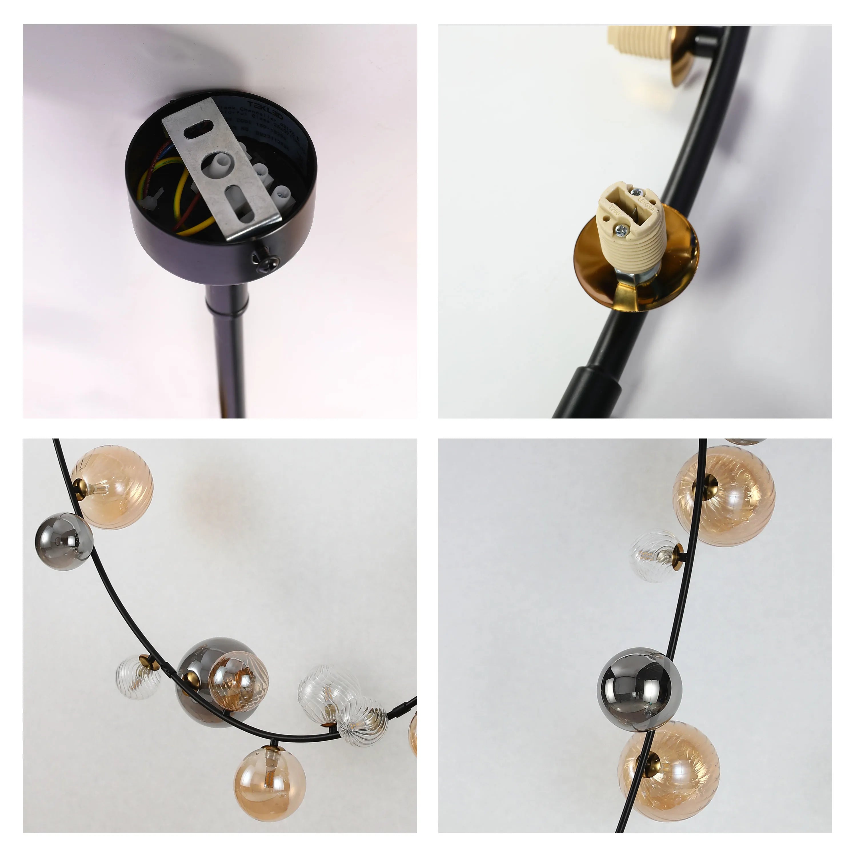 A modern chandelier with glass globes in amber, clear, and smoky grey. A black fitting complements the subtle colours.