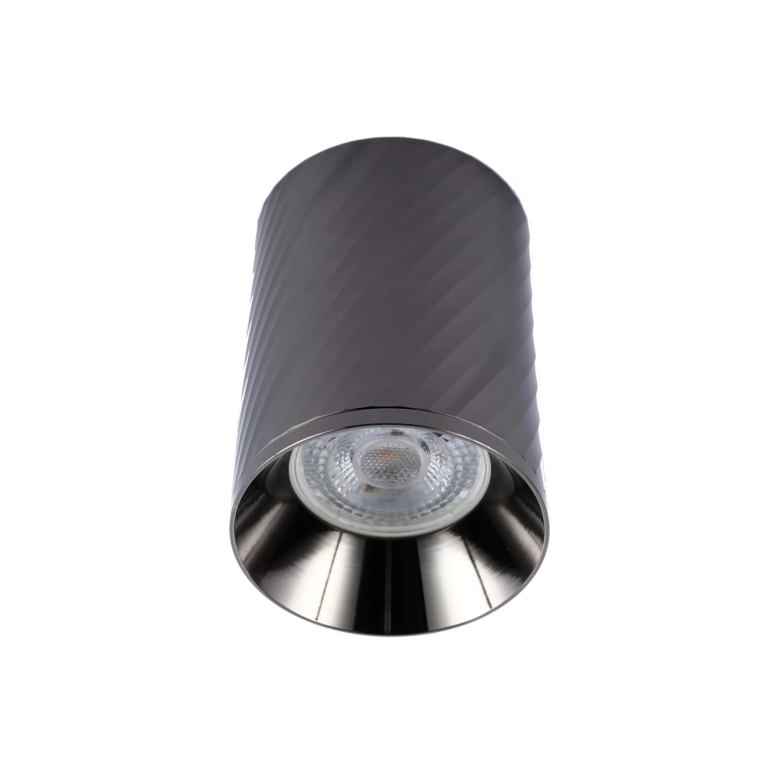 A cylindrical, surface-mounted downlight with a textured finish, casting a bright, focused beam. Modern and stylish.