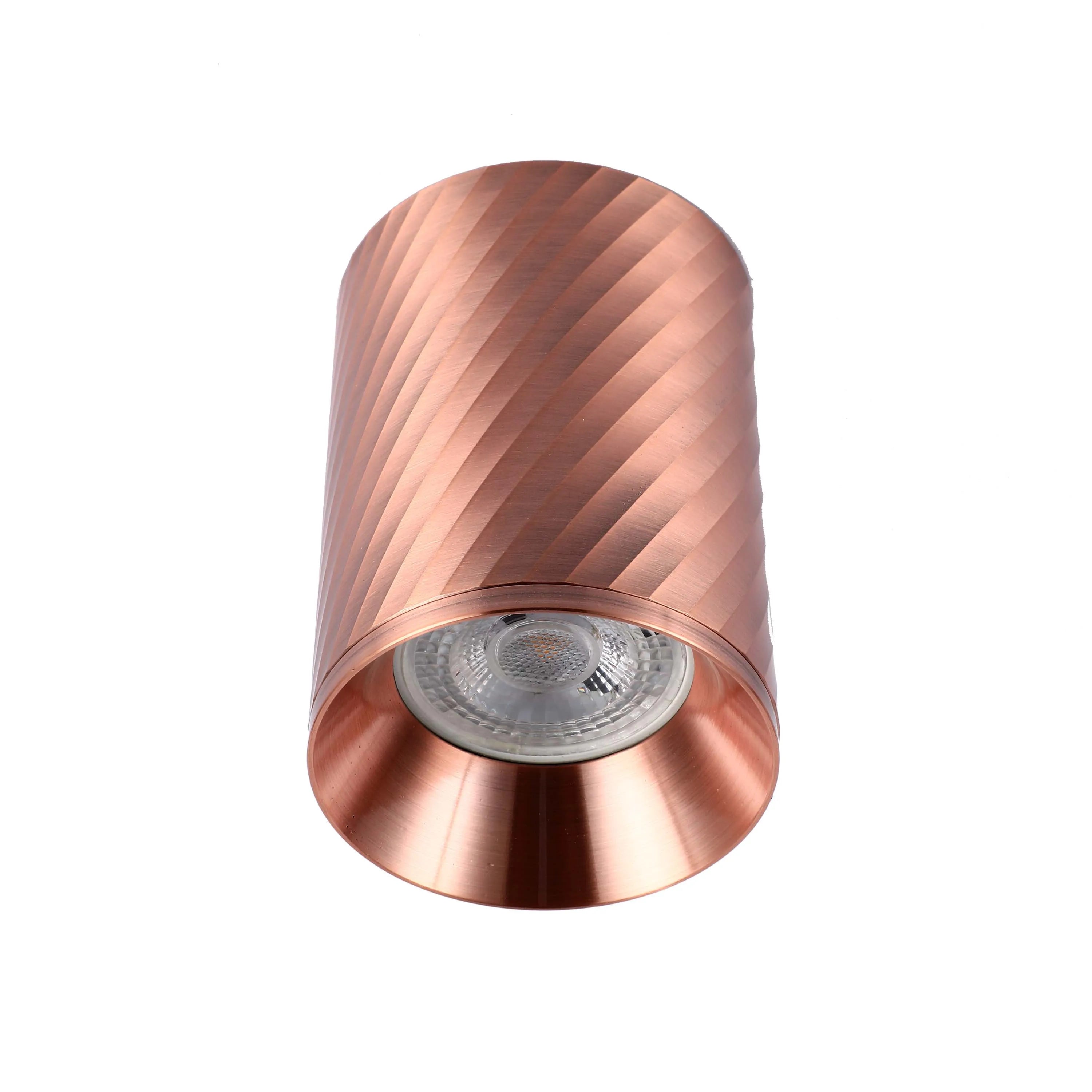 A copper, cylindrical spotlight with a swirling pattern, perfect for modern, minimalist lighting design.